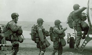 82nd Airborne troops move an SS prisoner to their lines near