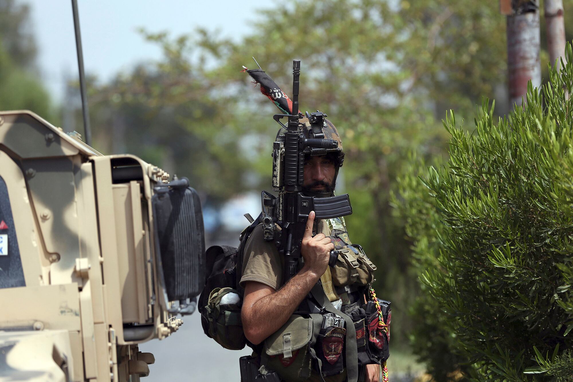 An Afghan security person stands guard near a prison after an attack in the city of Jalalabad, east of Kabul, Afghanistan, Monday, Aug. 3, 2020.