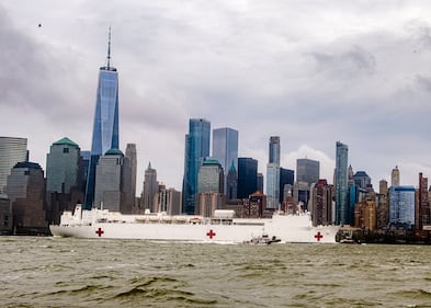 The hospital ship USNS Comfort (T-AH 20) departs New York Harbor