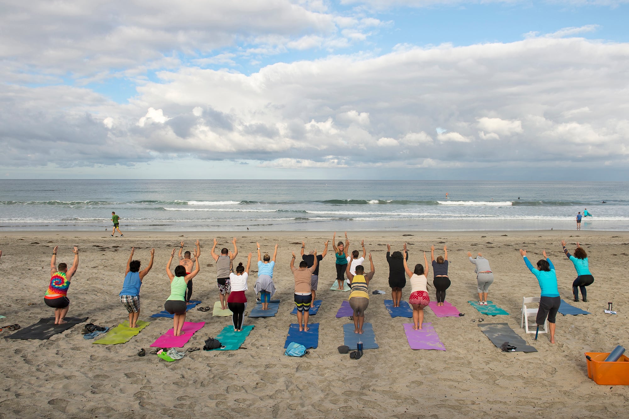 Waves break along the shore as patients yoga during a Naval Medical Center San Diego yoga therapy session on the beach in Del Mar Calif., Sept. 14, 2017.