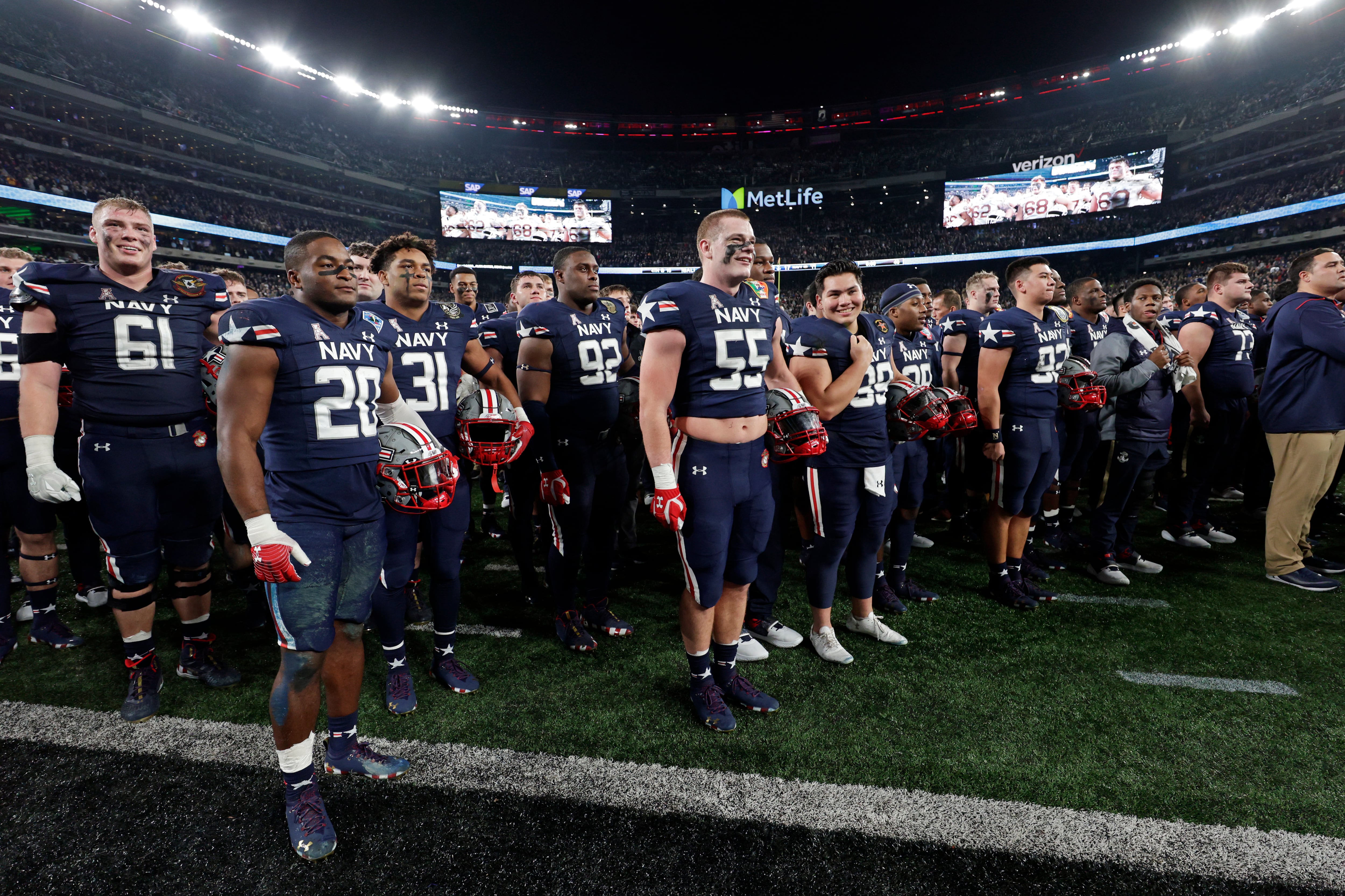 Navy listens to Army alma mater after an NCAA college football game Saturday, Dec. 11, 2021, in East Rutherford, N.J. Navy won 17-13. (AP Photo/Adam Hunger)