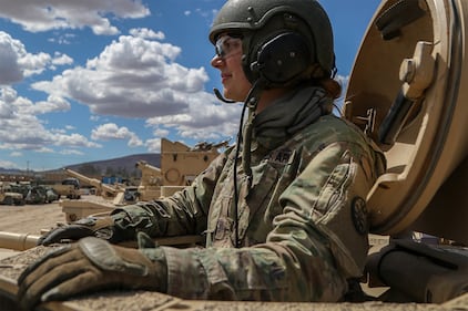 Army 2nd Lt. Caitlyn Simpson prepares her platoon for a training mission from inside a tank at Fort Irwin, Calif.