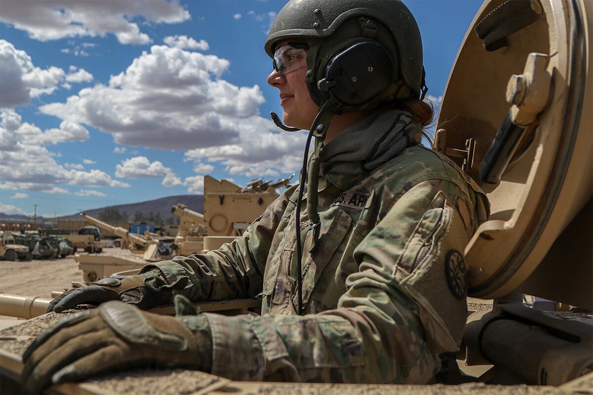 Army 2nd Lt. Caitlyn Simpson prepares her platoon for a training mission from inside a tank at Fort Irwin, Calif.