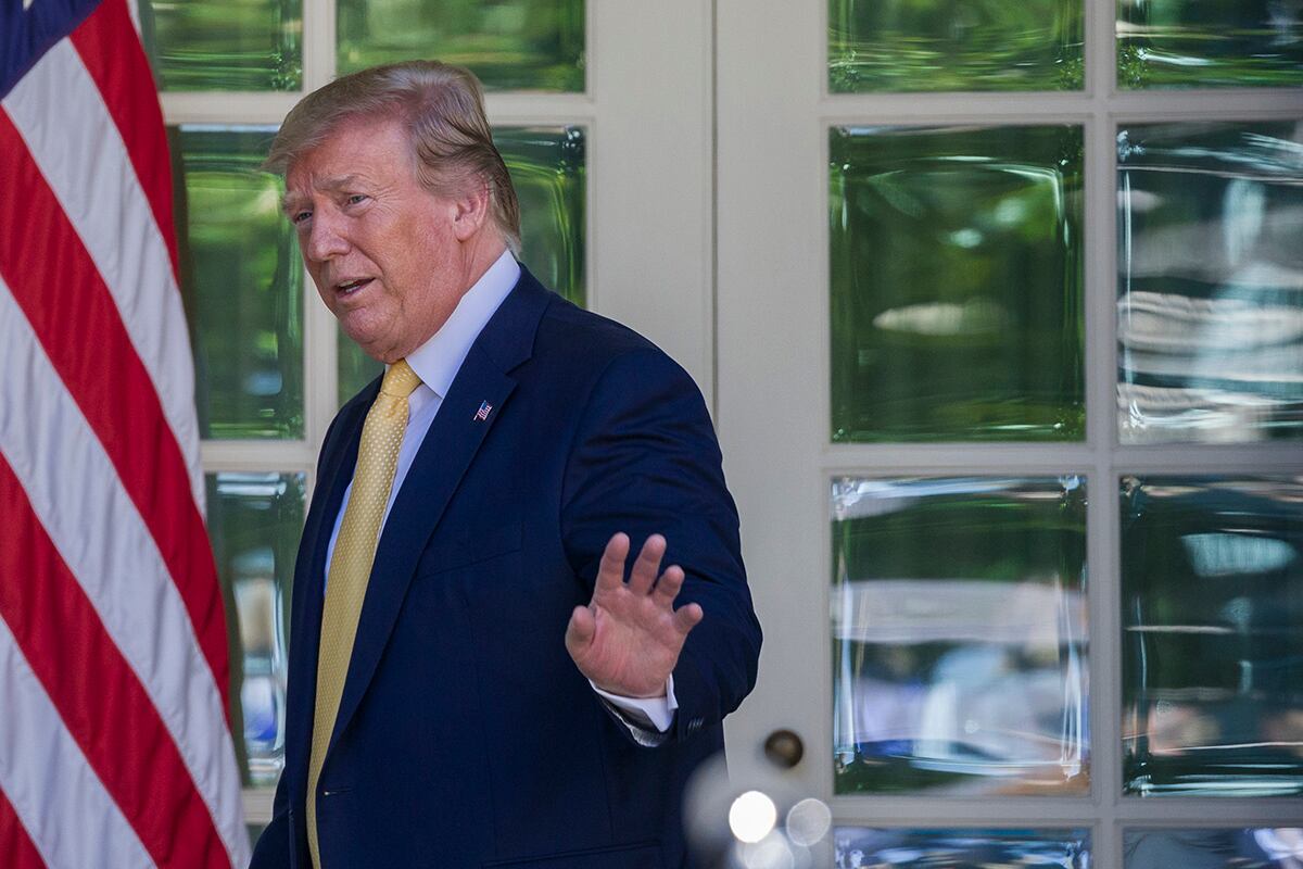 President Donald Trump waves as he departs after speaking in the Rose Garden of the White House