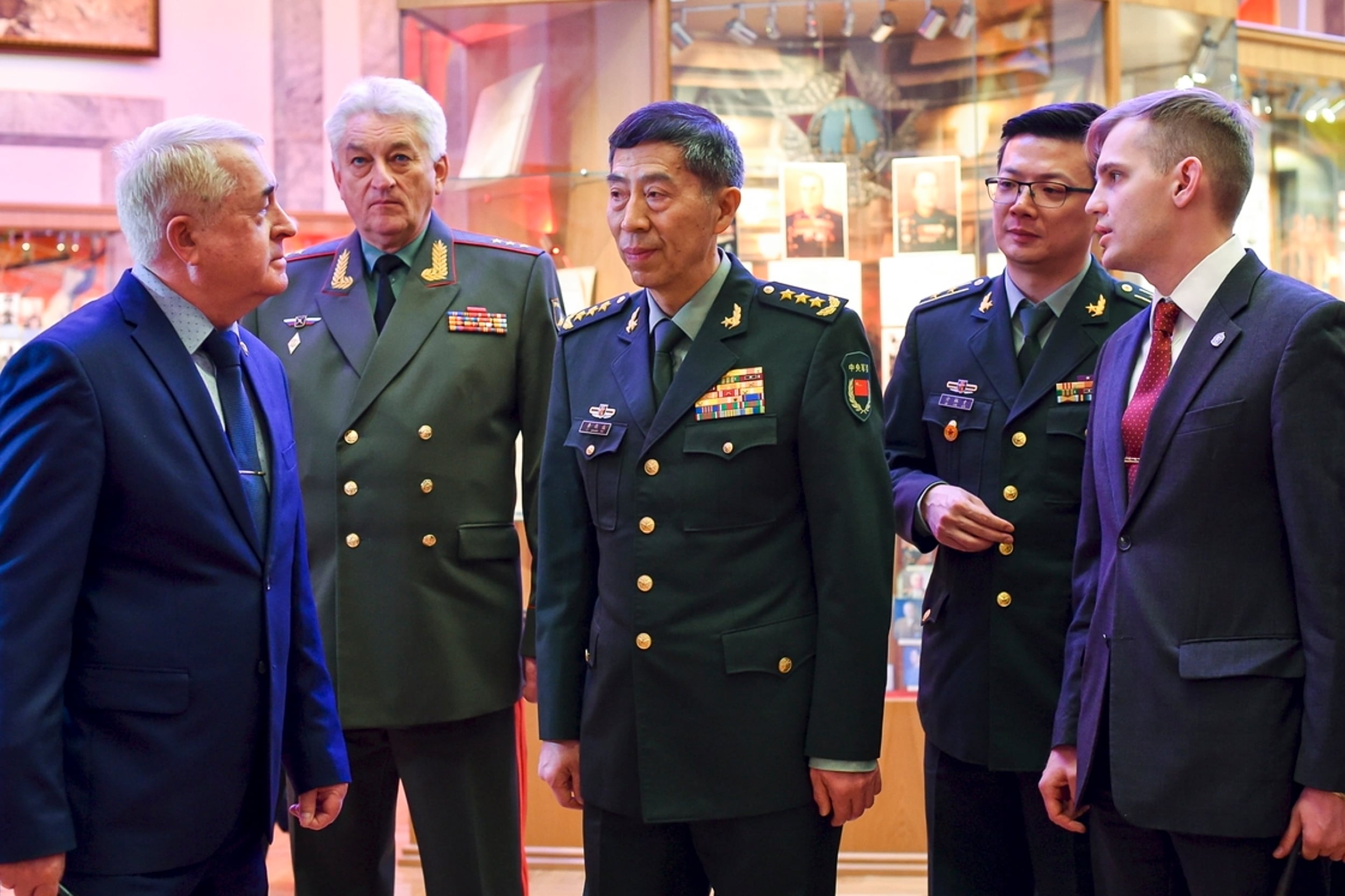 In this handout photo released by Russian Defense Ministry Press Service, China's Defense Minister Gen. Li Shangfu speaks to academy teachers as Chief of the Military Academy of the General Staff of the Armed Forces of the Russian Federation Col. Gen. Vladimir Zarudnitsky stands left of him during a visit to Military Academy of the General Staff of the Armed Forces of the Russian Federation in Moscow, Russia, Monday, April 17, 2023.