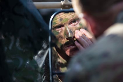 U.S. Army Command Sgt. Maj. Jason Beals applies camouflage Aug. 15, 2019, prior to an exercise during Combined Resolve XII at Hohenfels Training Area, Germany.