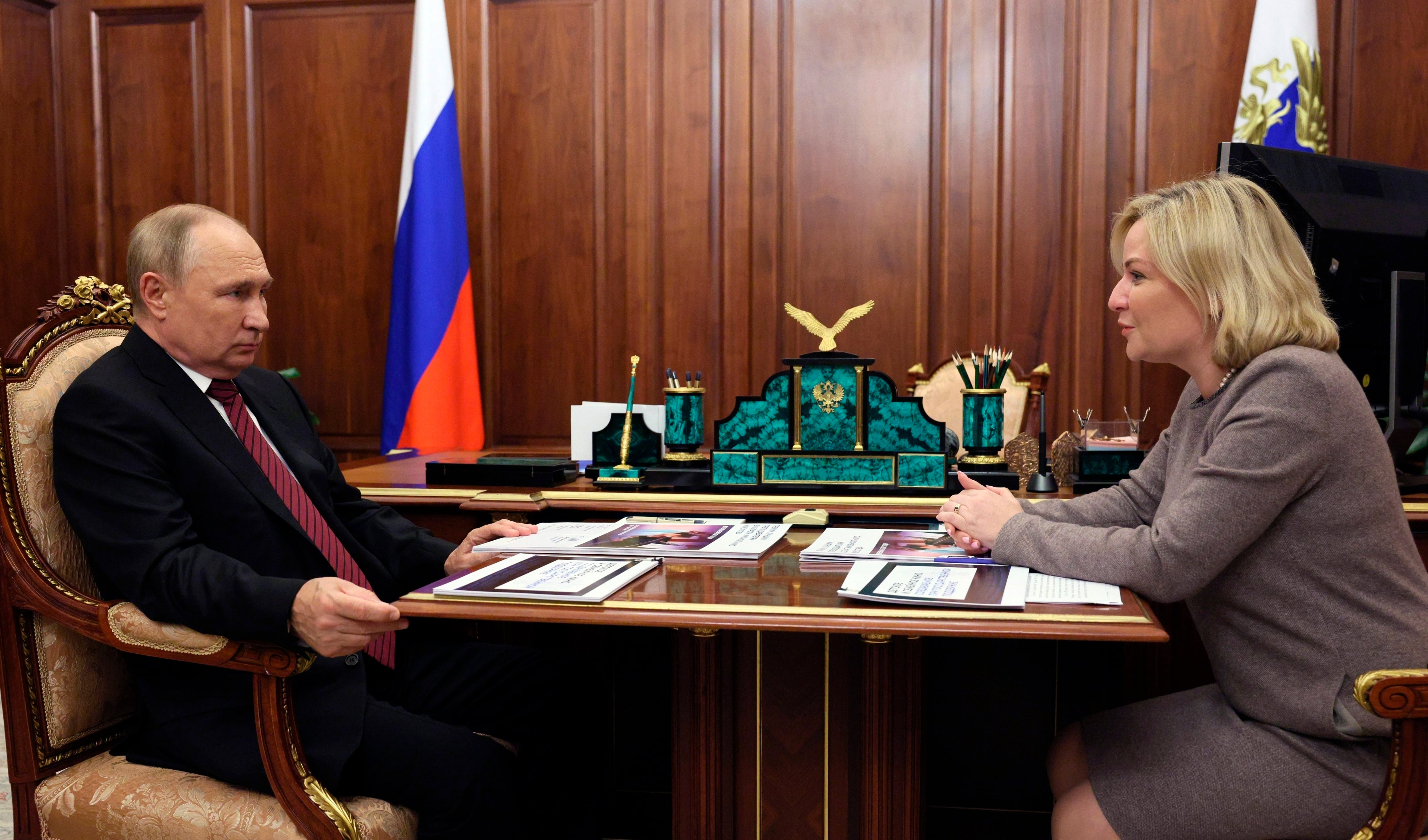 Russian President Vladimir Putin listens to Russian Culture Minister Olga Lyubimova during their meeting in Moscow, Russia, Oct. 3, 2022.