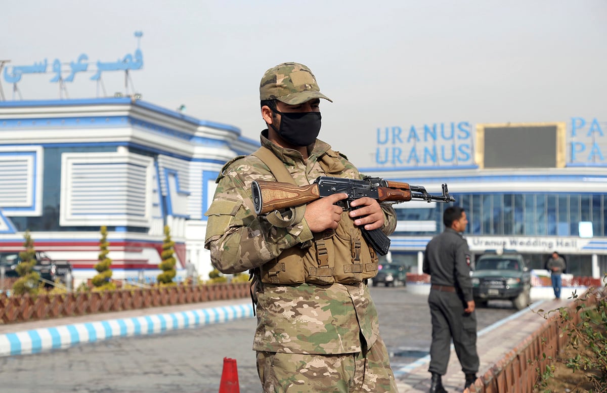 In this Nov. 21, 2018, file photo, an Afghan security officer stands guard outside a wedding hall in Kabul, Afghanistan.