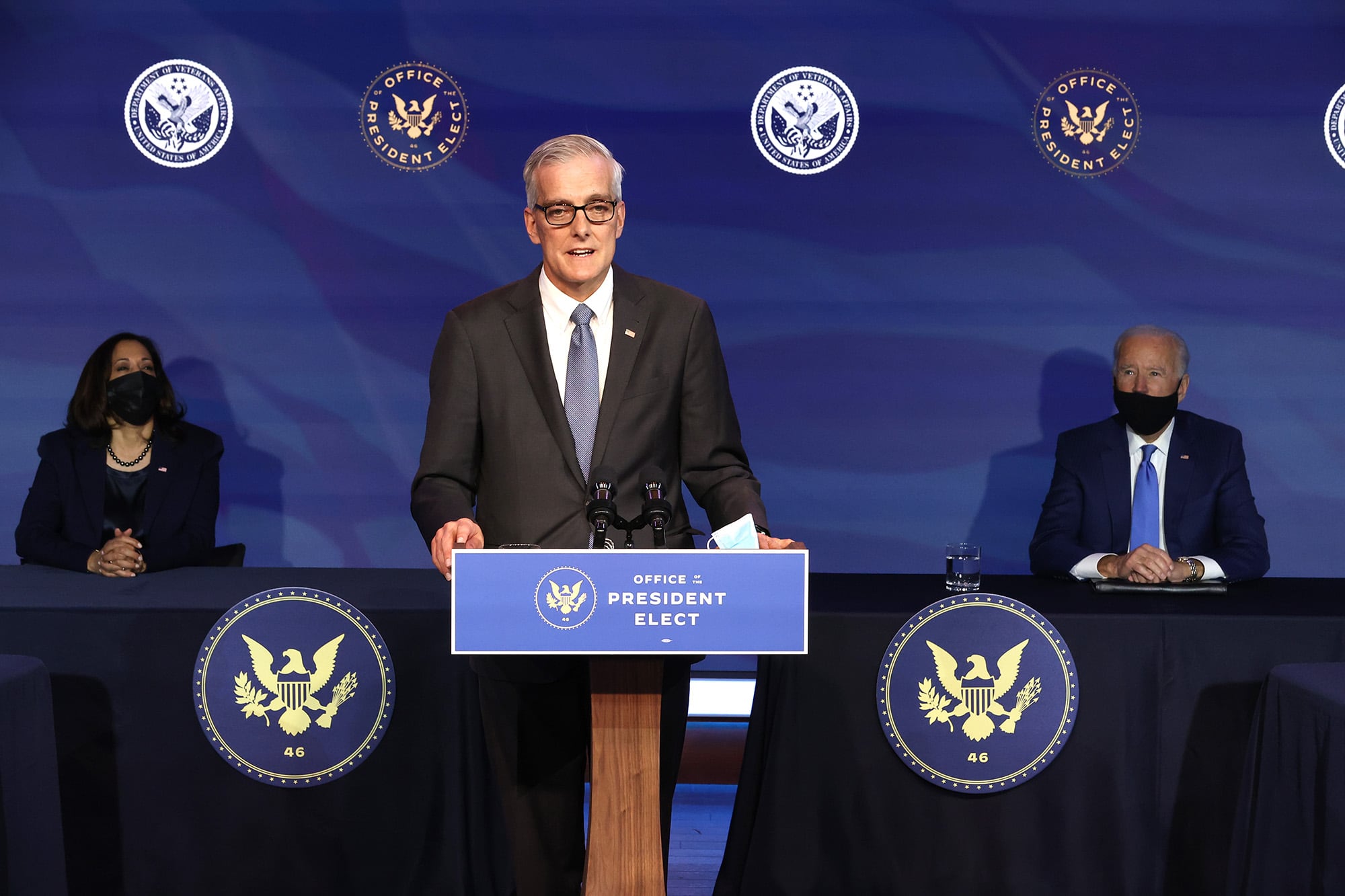 President-elect Joe Biden, right, and Vice President-elect Kamala Harris, left, look on as former Obama White House Chief of Staff Denis McDonough delivers remarks after being introduced as Biden’s nominee to head the Department of Veterans Affairs at the Queen Theater on Dec. 11, 2020 in Wilmington, Del.