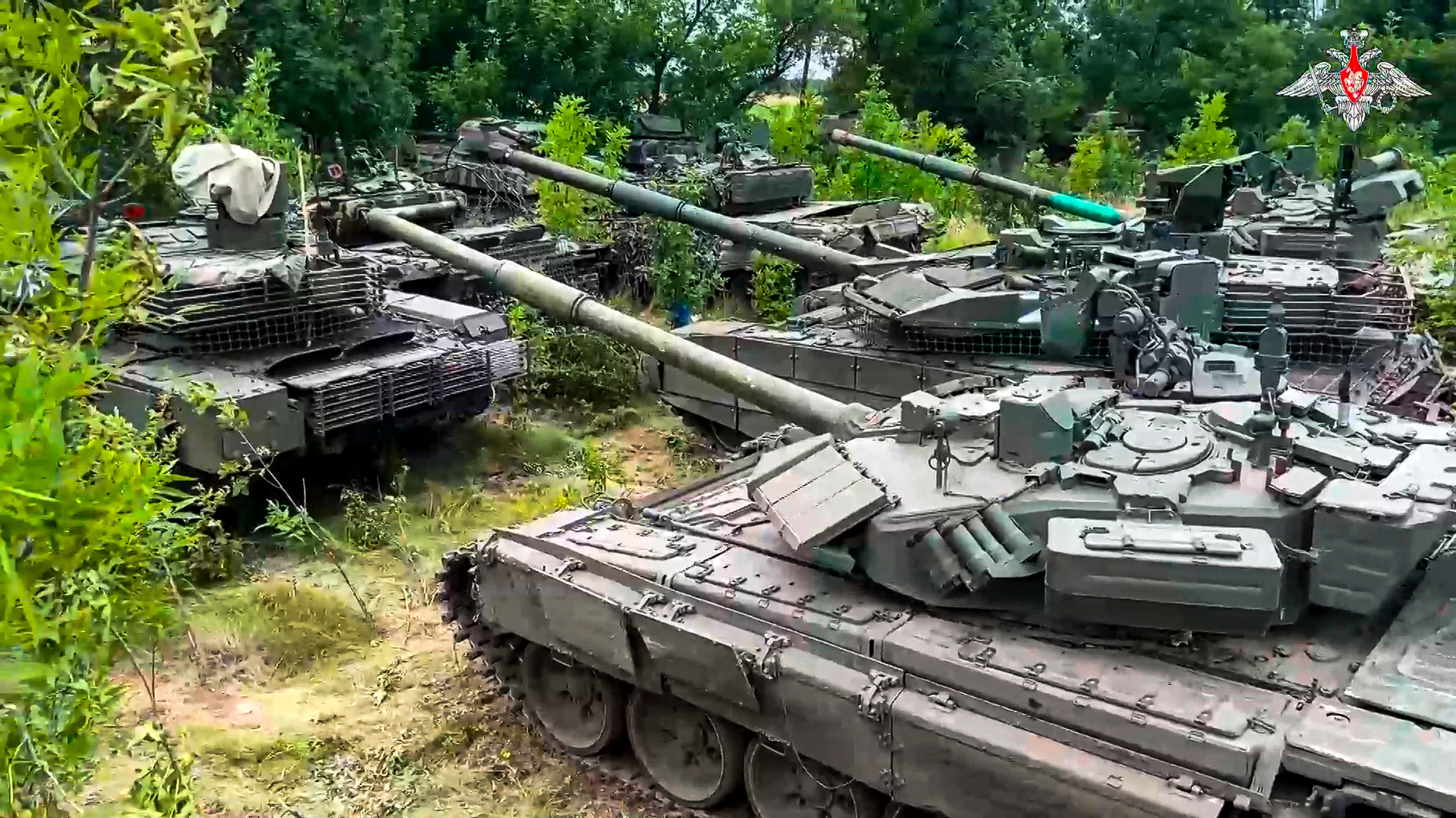 In this photo released by Russian Defense Ministry Press Service on Wednesday, July 12, 2023, Tanks belonging to Russia's Wagner military contractor are parked ahead of their handover to the Russian military at an undisclosed location.