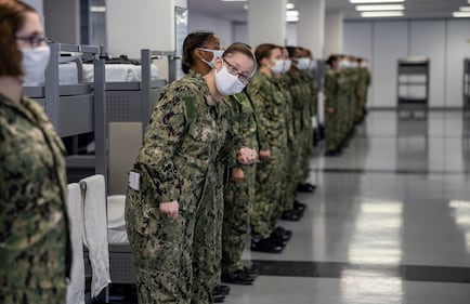 Seaman recruit Shanda Martinez, a recruit chief petty officer, checks to see if her division is ready for their first task during a dynamic material inspection Dec. 21, 2020, at Recruit Training Command at Great Lakes, Ill.