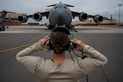 Senior Airman Sara Gutherie, 911th Aircraft Maintenance Squadron instruments and controls technician, adjusts her headset to communicate with maintainers inside the C-17 Globemaster III during an inspection at the Pittsburgh International Airport Air Reserve Station, Pa., Sept. 17, 2020.