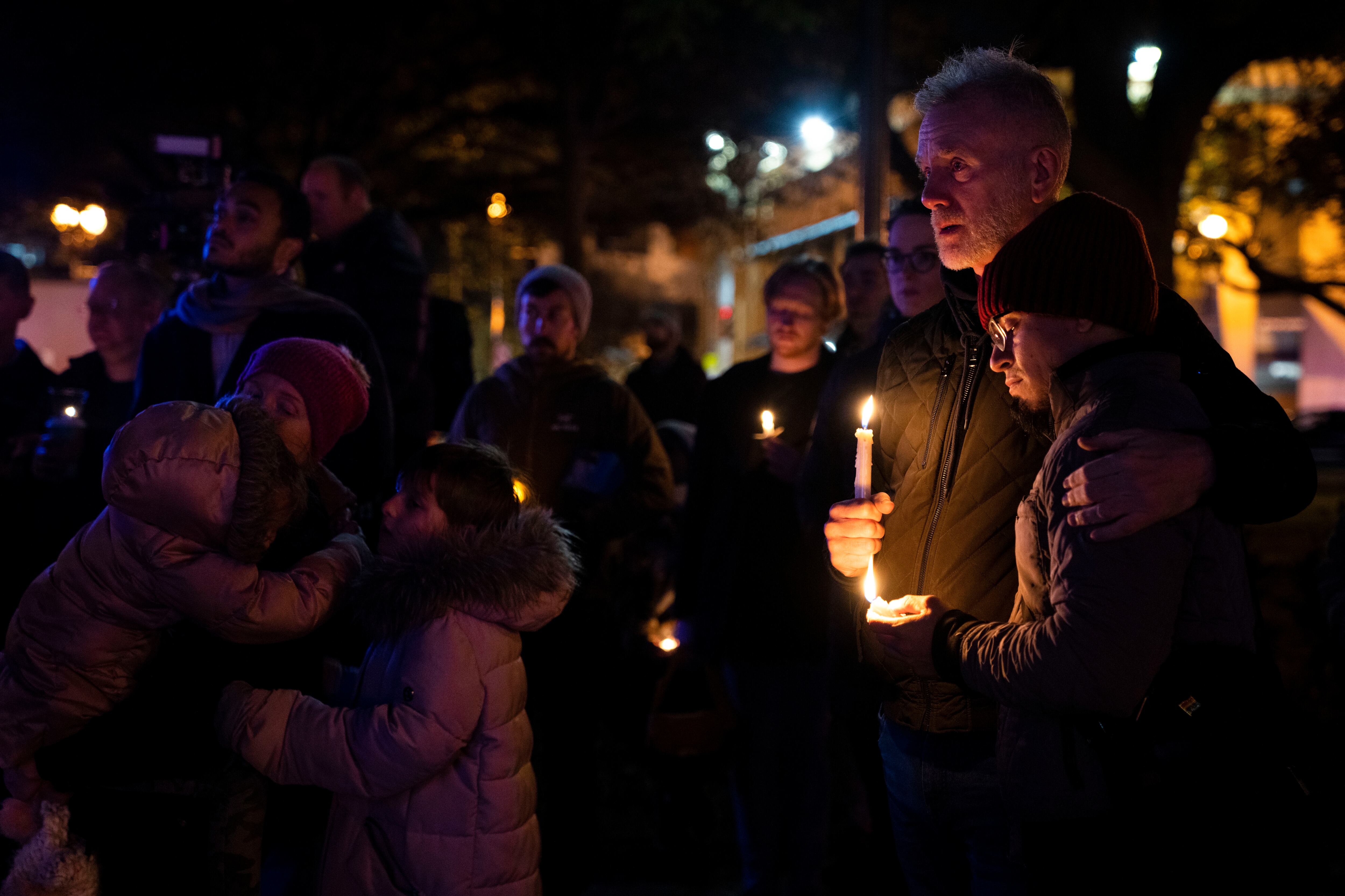 Robert McRuer, and Santy Rodelo, right, both of Washington, embrace during a candlelight vigil held in Dupont Circle, Monday, Nov. 21, 2022, in Washington, in memory of the victims of a gunman who opened fire with a semiautomatic rifle inside a gay nightclub in Colorado Springs.