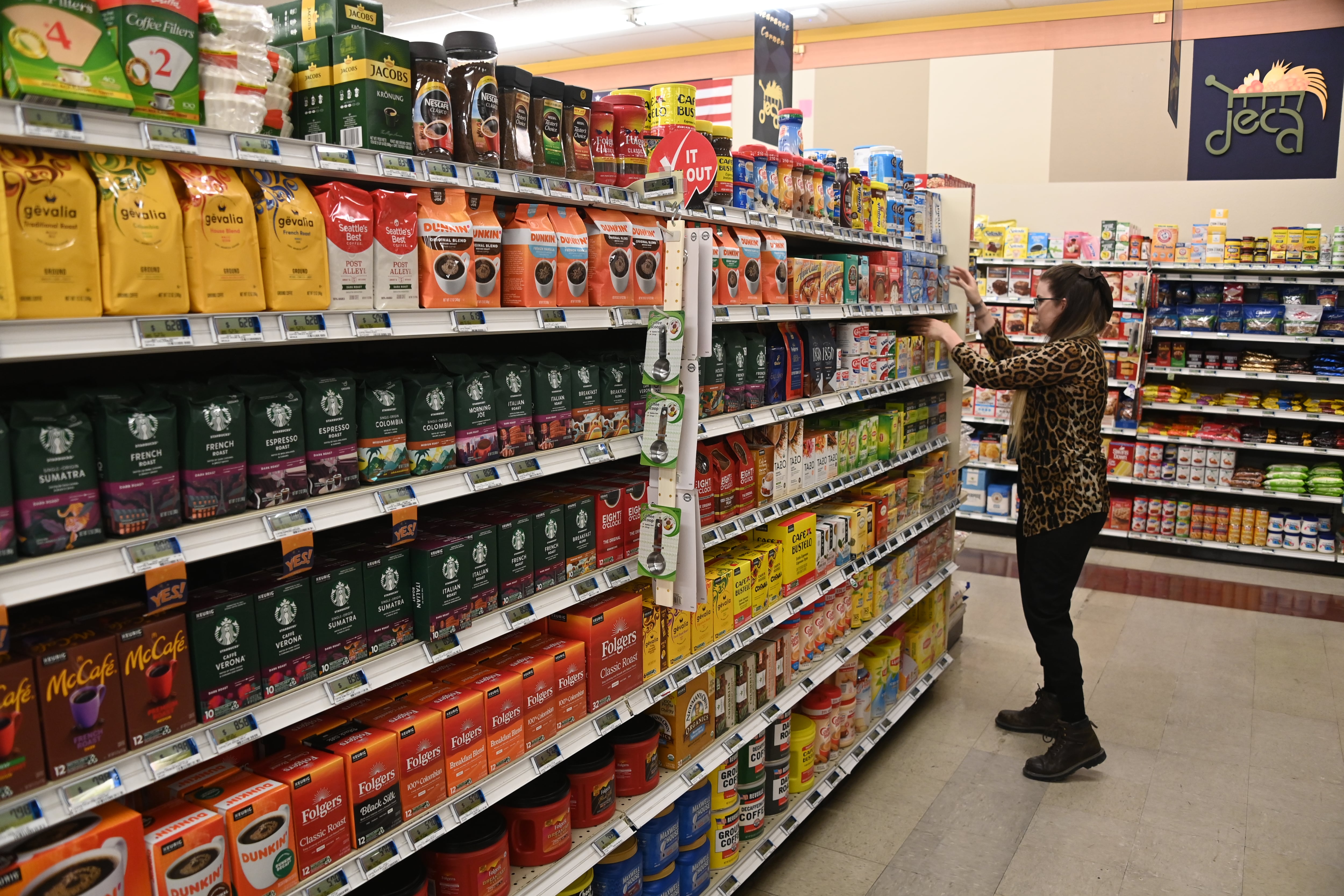 A store worker fronts merchandise on shelves at the Yuma Proving Ground Commissary in June 2023.