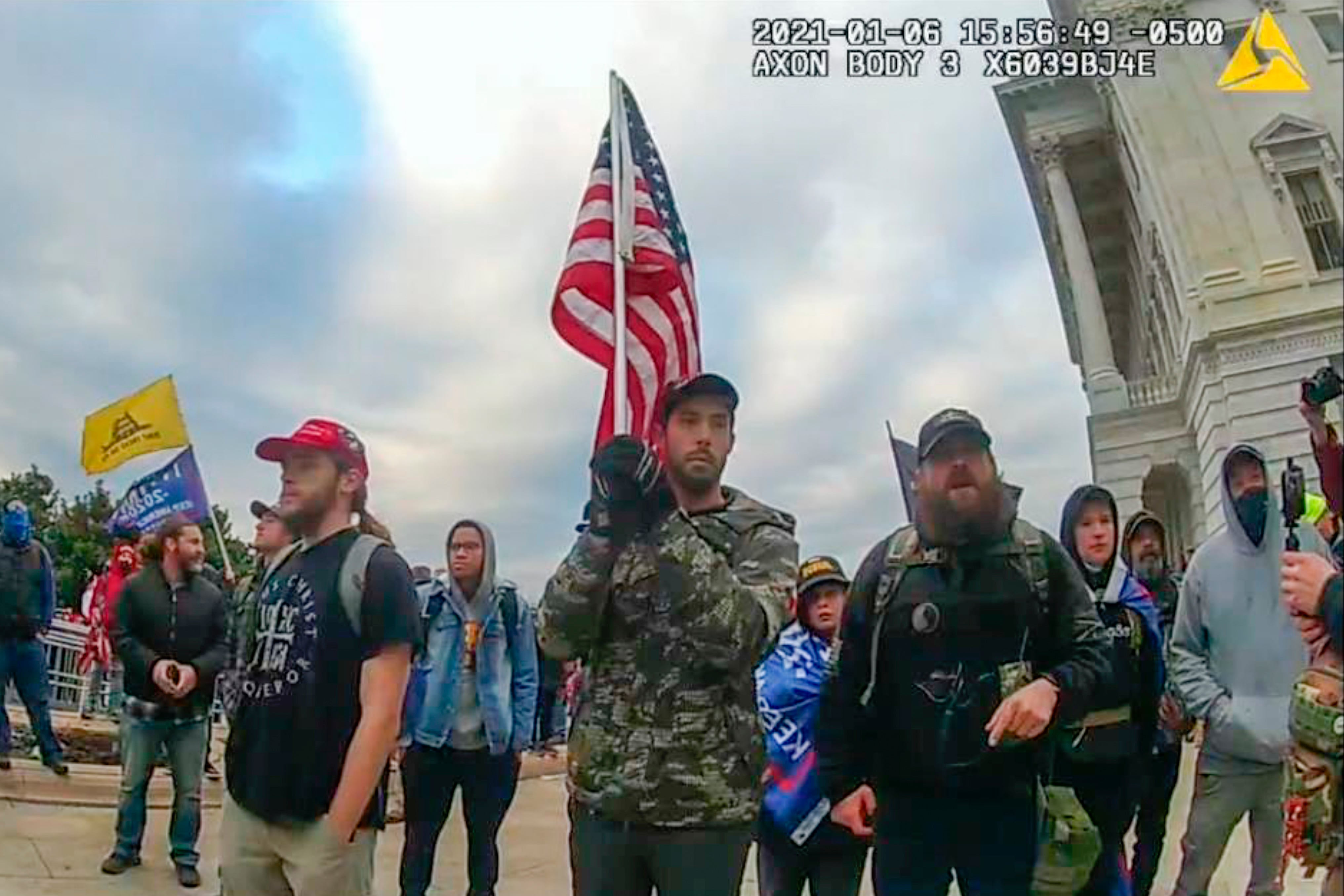 In this image from video provided by the Justice Department in the government's sentencing memo for Christopher Michael Alberts, right, yells at U.S. Capitol Police offices during the Jan. 6, 2021, riot at the U.S. Capitol.