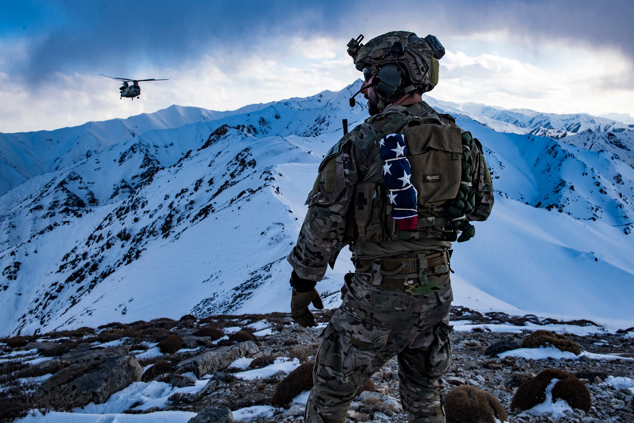 An Air Force pararescueman, assigned to the 83rd Expeditionary Rescue Squadron, communicates with an Army Task Force Brawler CH-47F Chinook during a training exercise at an undisclosed location in the mountains of Afghanistan, March 14, 2018.