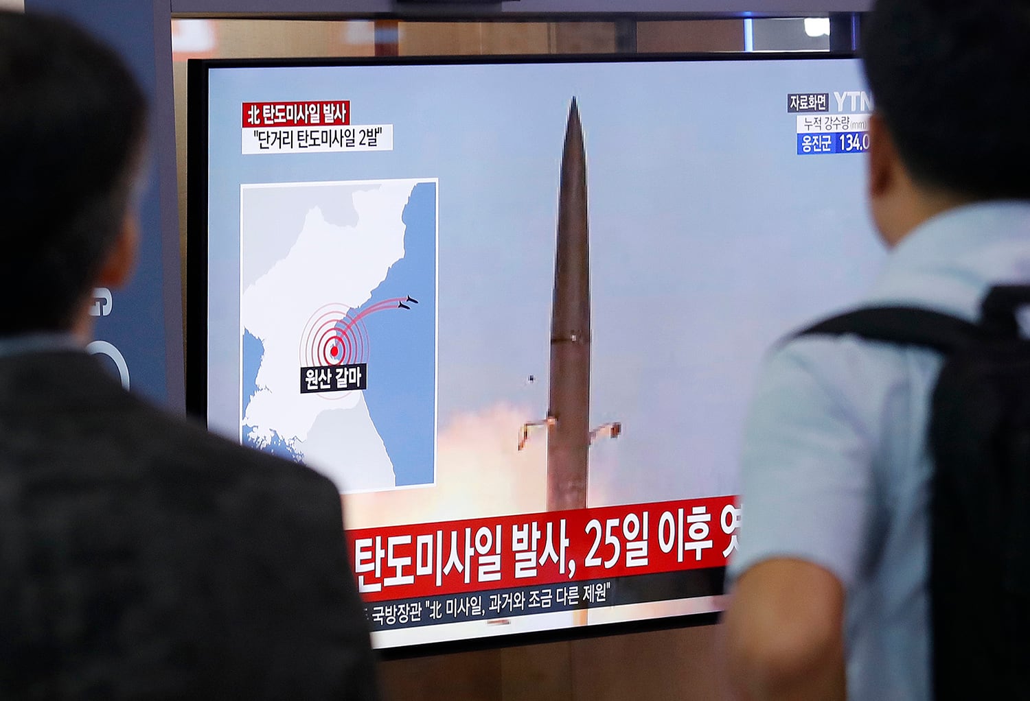 People watch a TV showing a file image of North Korea's missile launch during a news program at the Seoul Railway Station in Seoul, South Korea, Wednesday, July 31, 2019.