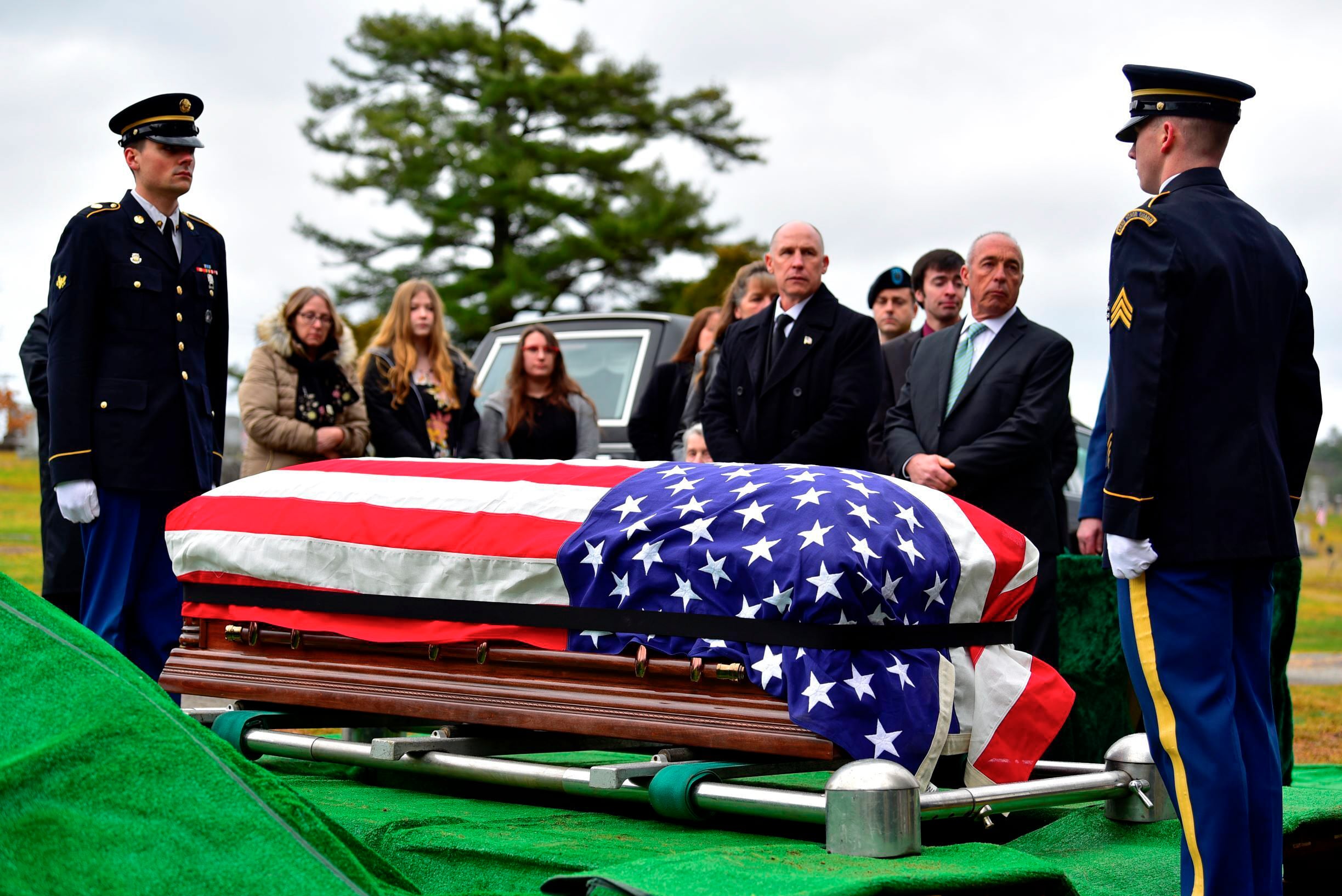 Family members surround the casket of Army Sgt. Alfred Sidney at his burial service in Littleton, N.H., on Thursday, Dec. 8, 2022.