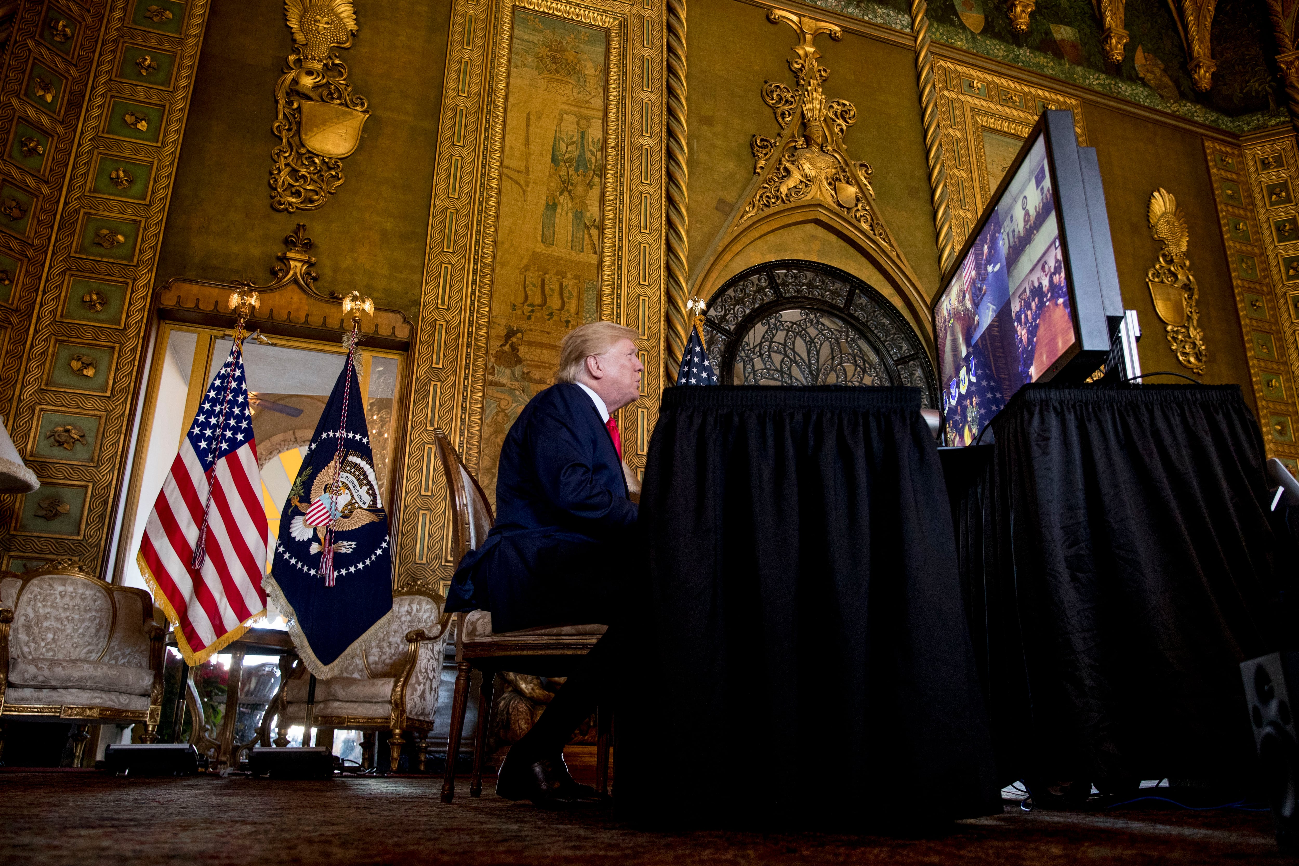 President Donald Trump speaks during a Christmas Eve video teleconference with members of the military