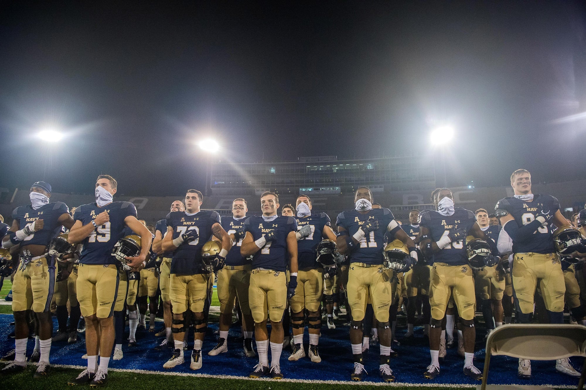 U.S. Naval Academy players sing "Navy Blue and Gold," their alma mater song on Oct. 3, 2020, following the Navy vs. Air Force football game in Falcon Stadium at the U.S. Air Force Academy.