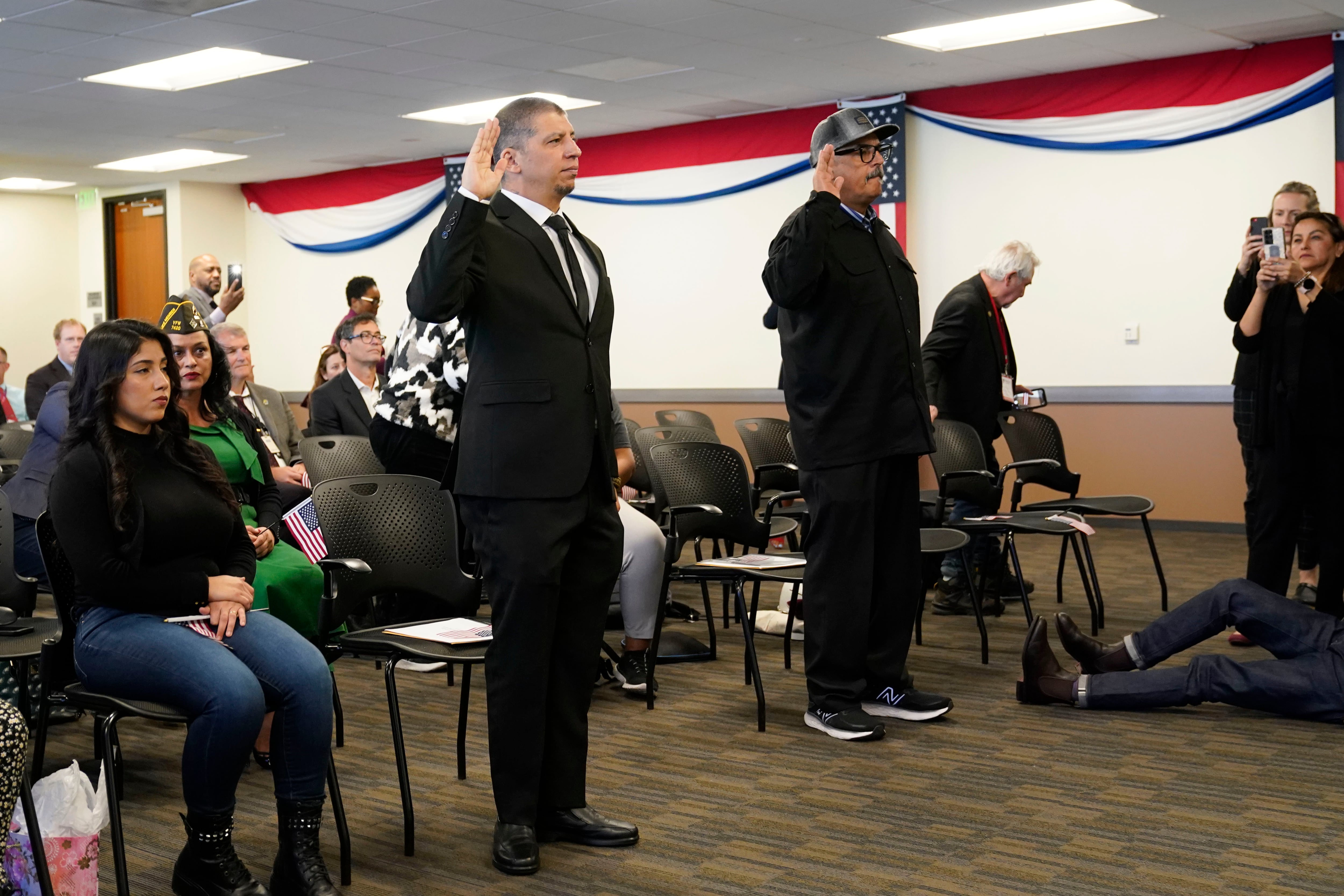 Deported veterans Mauricio Hernandez Mata, standing at left, and Leonel Contreras, standing at right, are sworn in as U.S. citizens at a special naturalization ceremony Wednesday, Feb. 8, 2023, in San Diego.