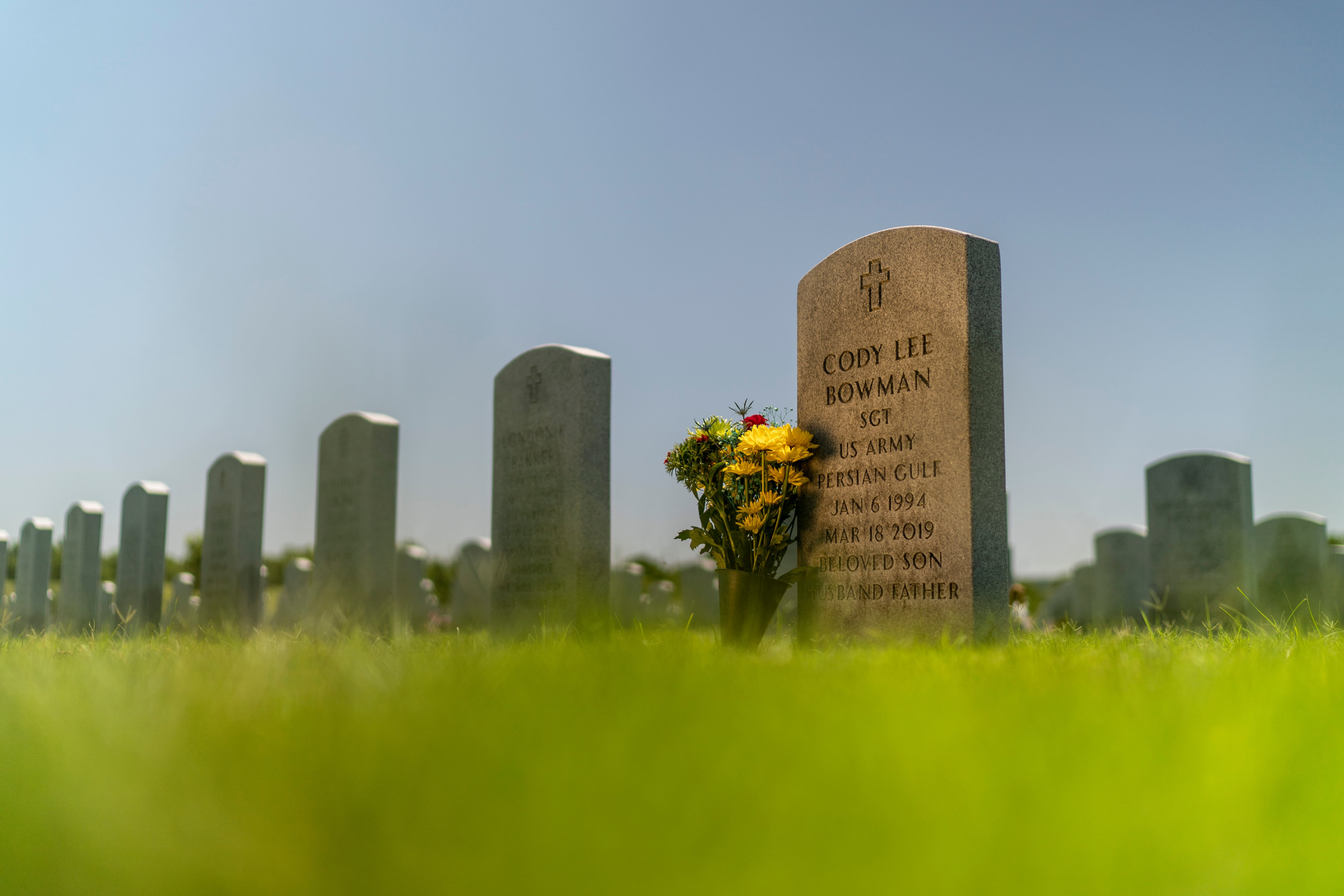 The tombstone of Army Sgt. Cody Bowman stands at the Dallas-Fort Worth National Cemetery, Sunday, June 11, 2023, in Dallas.