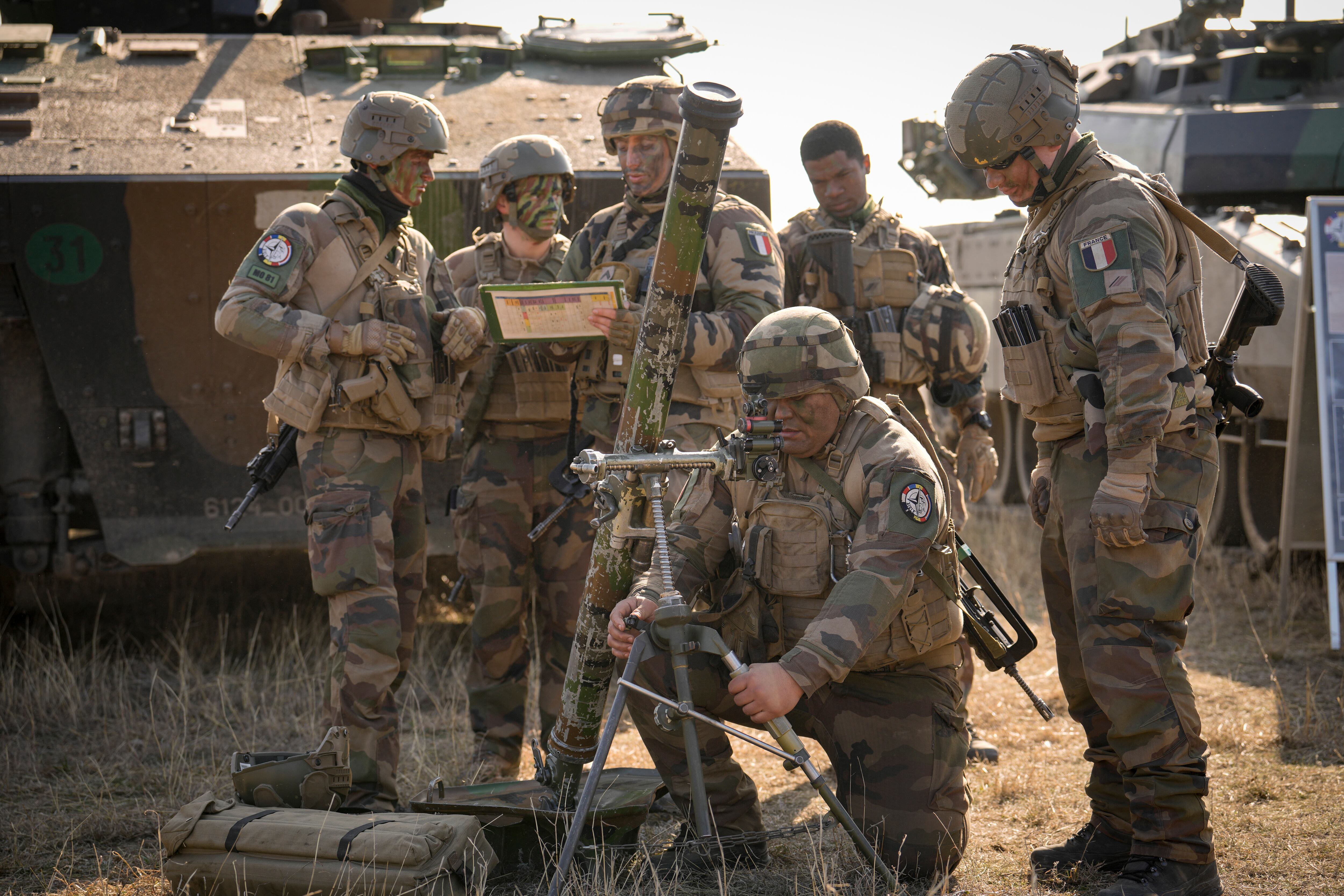 French serviceman operate a mortar during a joint French US exercise involving HIMARS and MLRP rocket launchers at a firing range in Capu Midia, on the Black Sea shore, Romania, Thursday, Feb. 9, 2023.