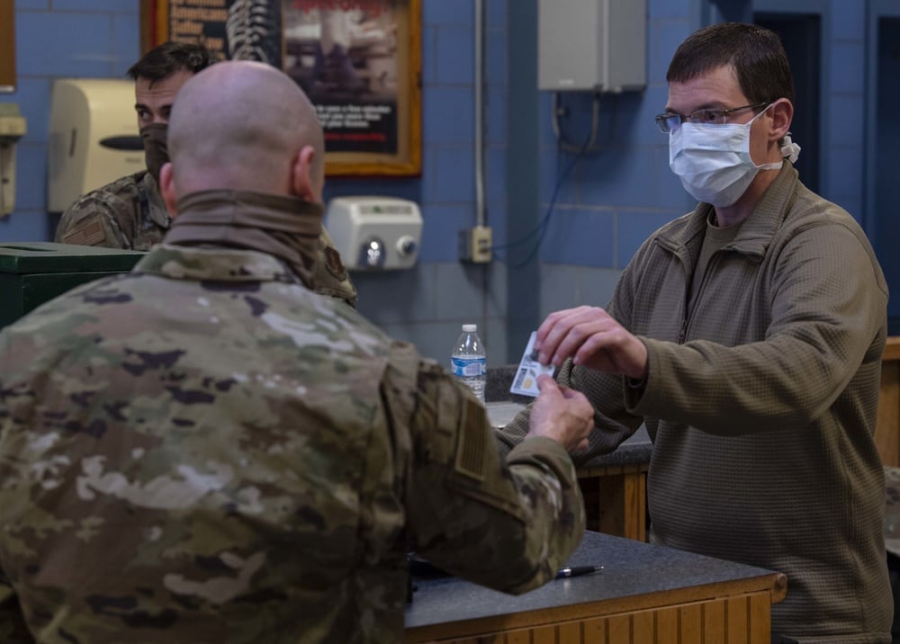 Tech. Sgt. Kristin Kingrey, an air transportation technician assigned to the 130th Logistic Readiness Squadron, takes identification cards from airmen to input into a database before deploying in support of Operation Freedom Sentinel on April 25, 2020, at McLaughlin Air National Guard Base, Charleston, West Virginia. (Master Sgt. De-Juan Haley/Air National Guard)