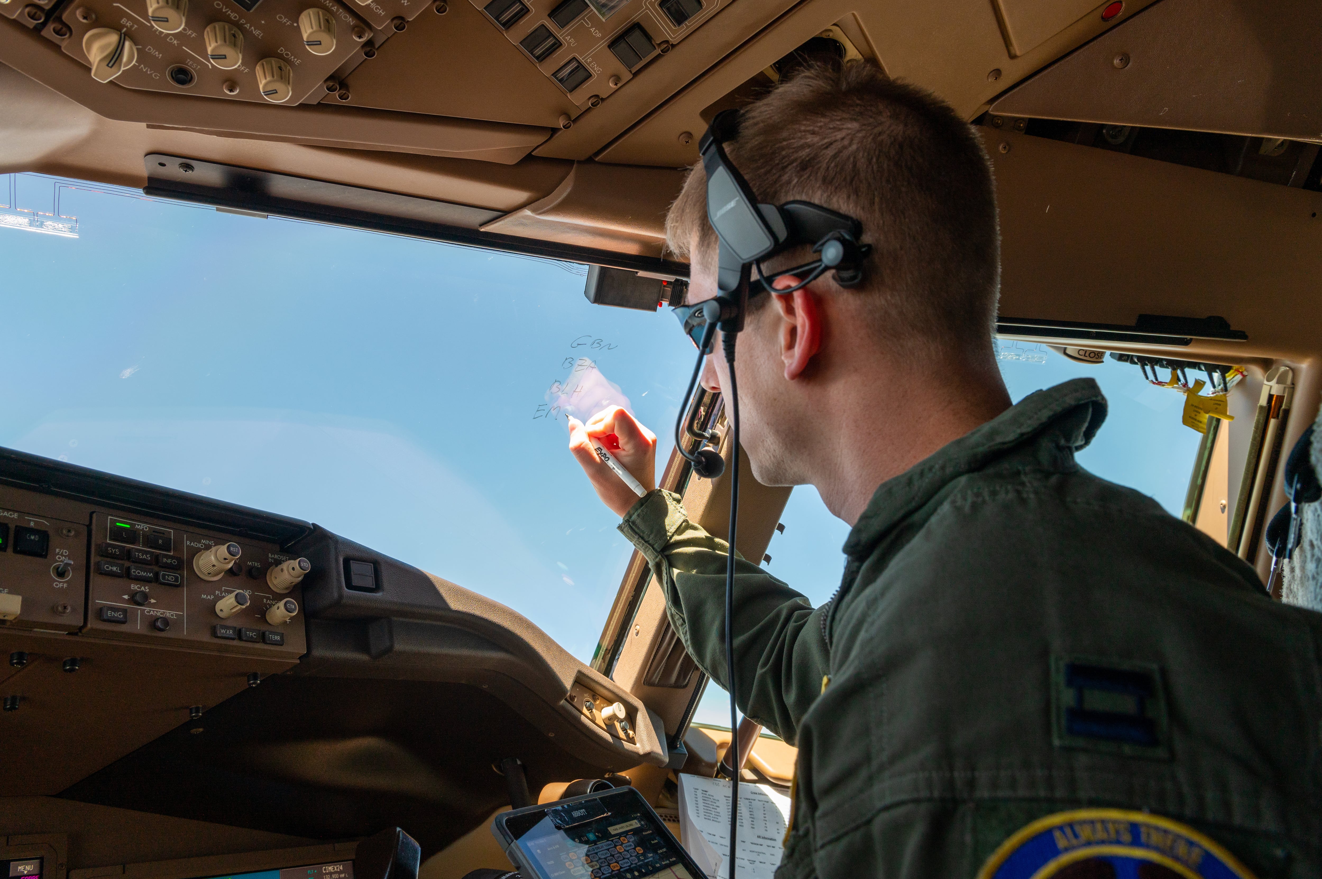 Capt. Kevin Abbott, 344th Air Refueling Squadron instructor pilot, coordinates route changes with the Los Angeles Air Traffic Control Center on May 5, 2022. Route changes were necessary to avoid thunderstorms while still make the air refueling control time with the receivers. (Airman Brenden Beezley/Air Force)