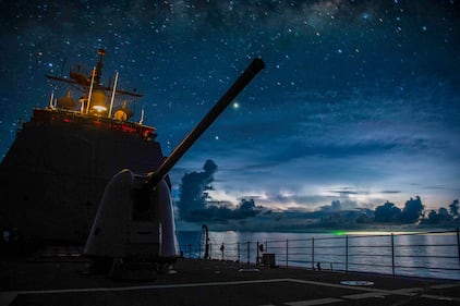 The Ticonderoga-class guided-missile cruiser USS Princeton (CG 59) steams through the night in the South China Sea on July 15, 2020.