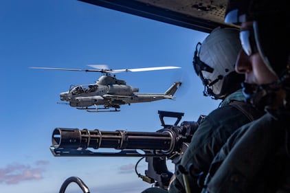 An AH-1Z Viper helicopter and a UH-1Y Venom helicopter fly alongside each other during an aerial gunnery range at Naval Air Facility El Centro, Calif., July 16, 2020.