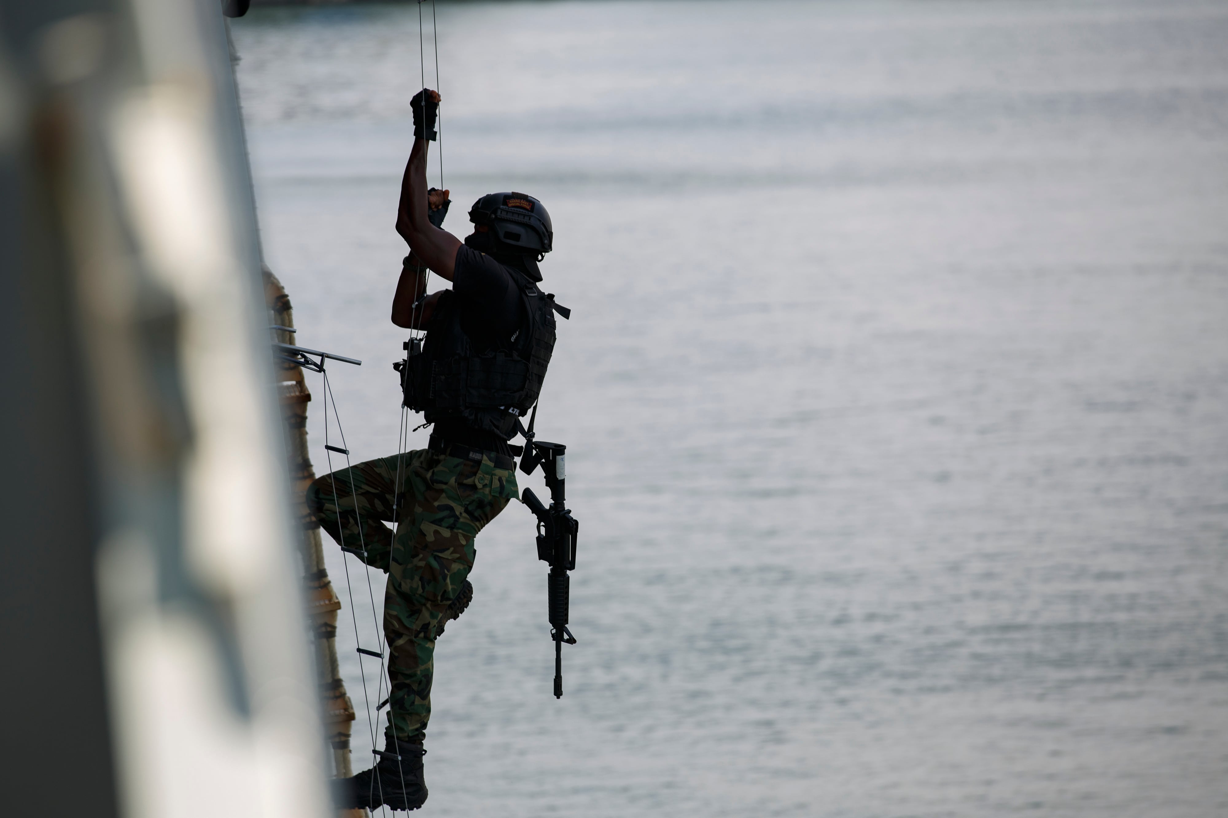 A Ghanaian soldier performs in hook and climb drills during Flintlock 2023 on a Spanish frigate at Tema port, Ghana, Thursday, March 9, 2023.