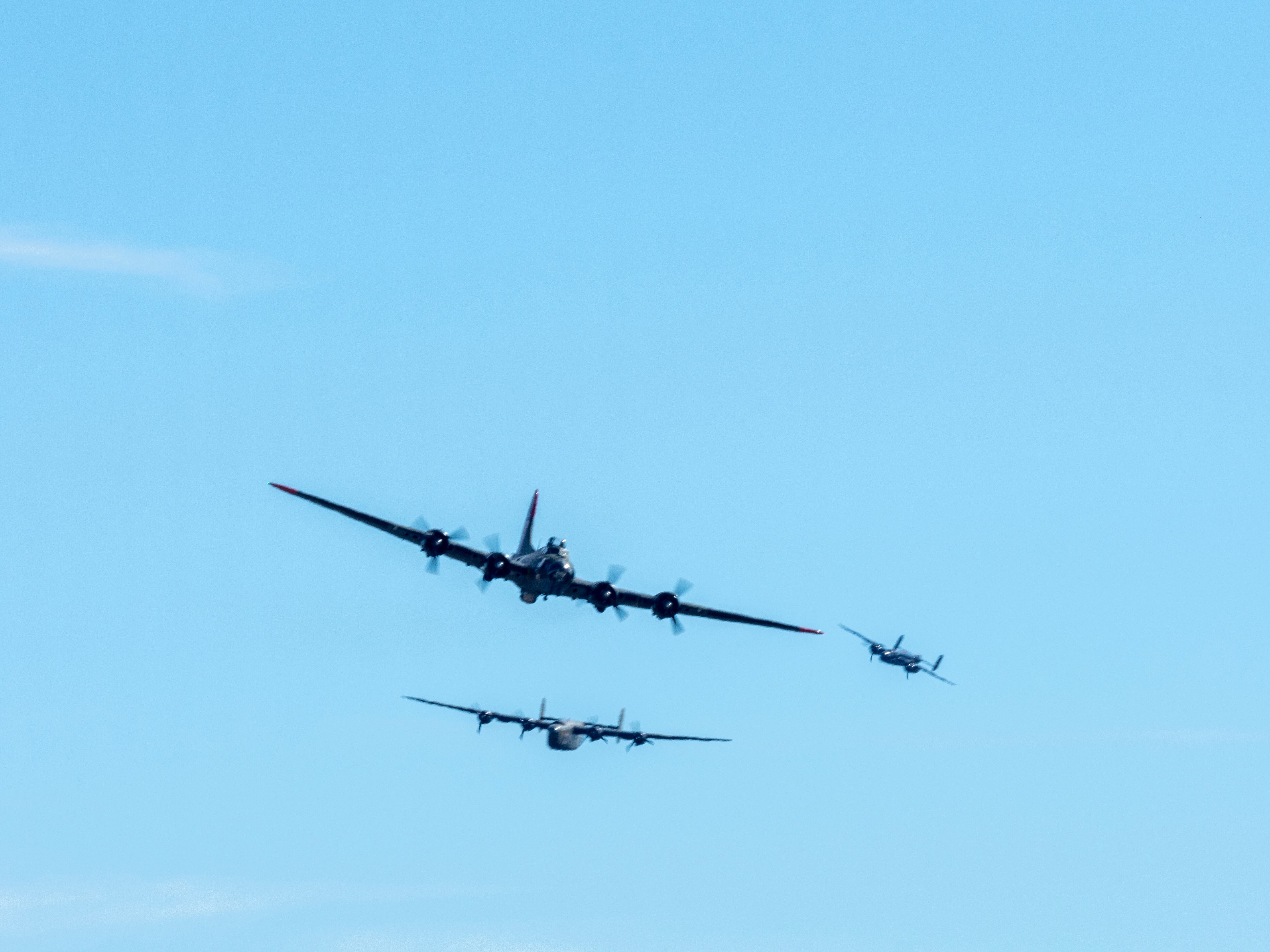 In this photo provided by Larry Petterborg, a Boeing B-17 Flying Fortress, front, is seen seconds before colliding with a Bell P-63 Kingcobra in the midair during an airshow at Dallas Executive Airport in Dallas, Saturday, Nov. 12, 2022.