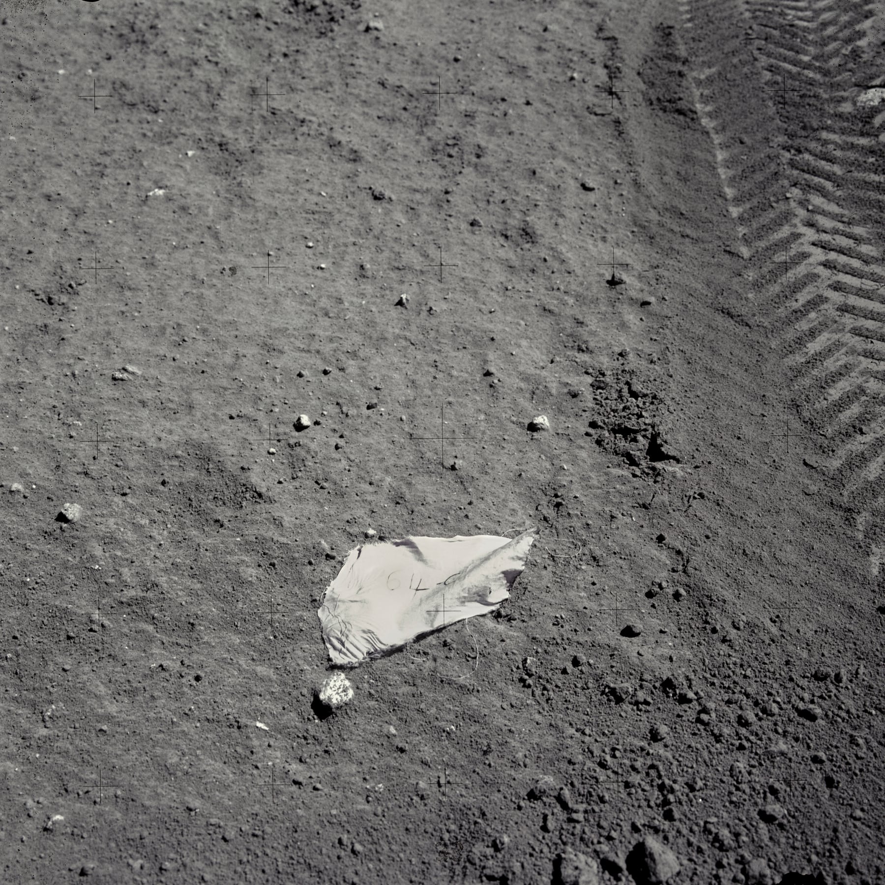 An image of a piece of spacesuit material with "64-C" written on it in honor of Apollo 16 astronaut Charlie Duke's class at the Air Force test pilot school. (NASA/Johnson Space Center/Arizona State University/Andy Saunders)