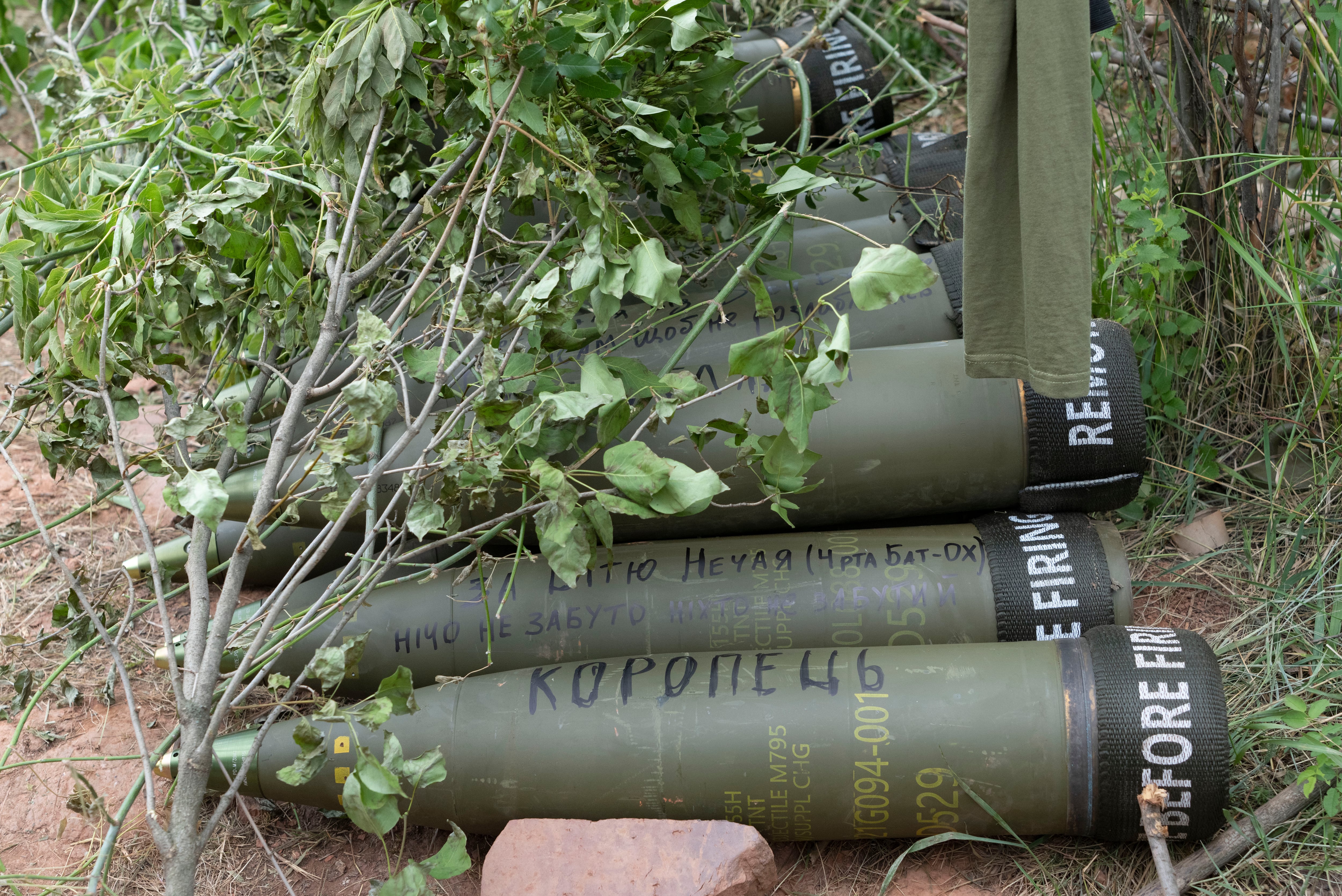 U.S.-supplied M777 howitzer shells lie on the ground to fire at Russian positions in Ukraine's eastern Donbas region June 18, 2022.