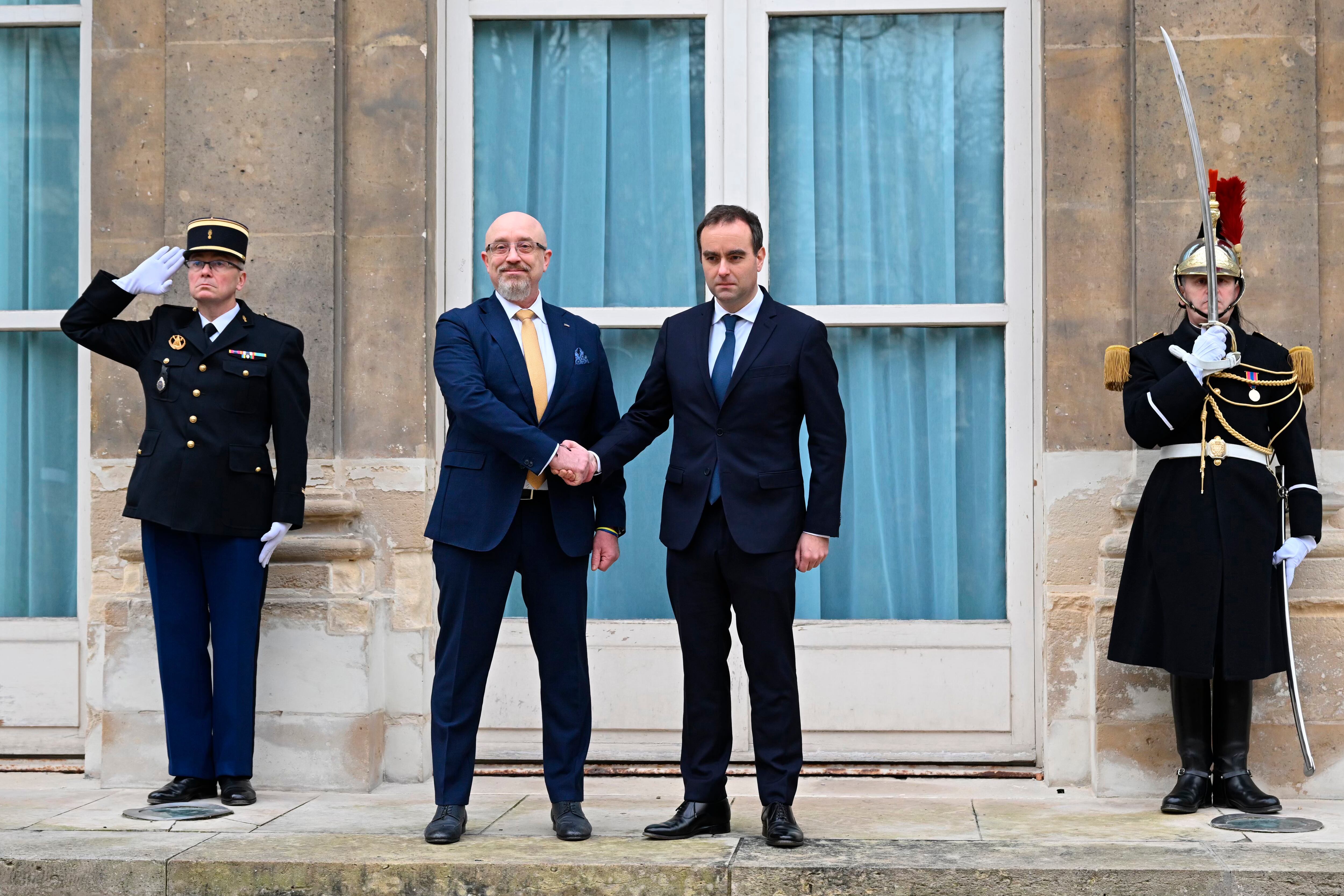 French Defense Minister Sebastien Lecornu, center right, and Ukrainian Minister of Defense Oleksii Reznikov pose during Reznikov's official visit at the French Defense Ministry, in Paris Tuesday, Jan. 31, 2023.