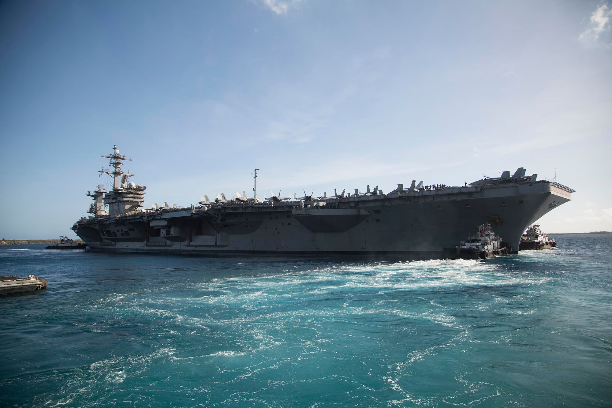 The aircraft carrier USS Theodore Roosevelt (CVN 71) departs Apra Harbor on May 21, 2020, following an extended visit to Guam in the midst of the COVID-19 global pandemic.