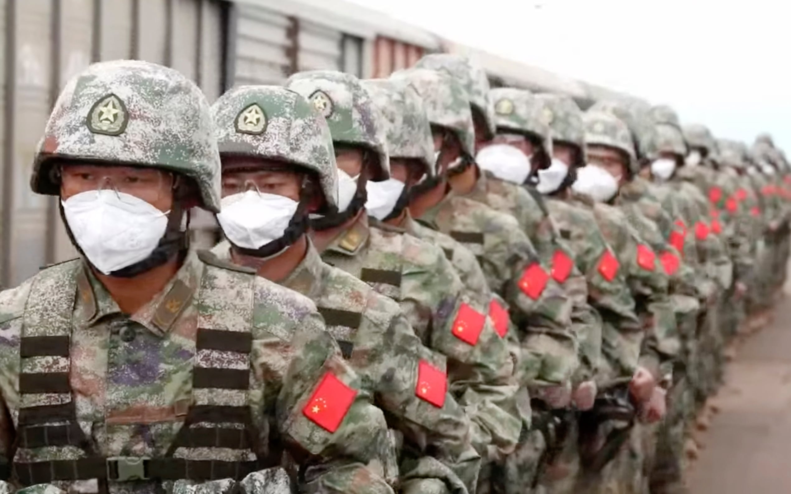 In this handout photo taken from video released by Russian Defense Ministry Press Service on Monday, Aug. 29, 2022, Chinese soldiers arrive to the Grodekovo railway station to participate in war games drills, in Grodekovo, Primorsky Krai, Russia.