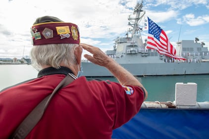 Military veteran Wendell Newman salutes the guided-missile destroyer USS Michael Murphy (DDG 112) during the pass in review portion of the 75th anniversary of the End of World War II commemoration ceremony at Pearl Harbor, Hawaii, Sept. 2, 2020.