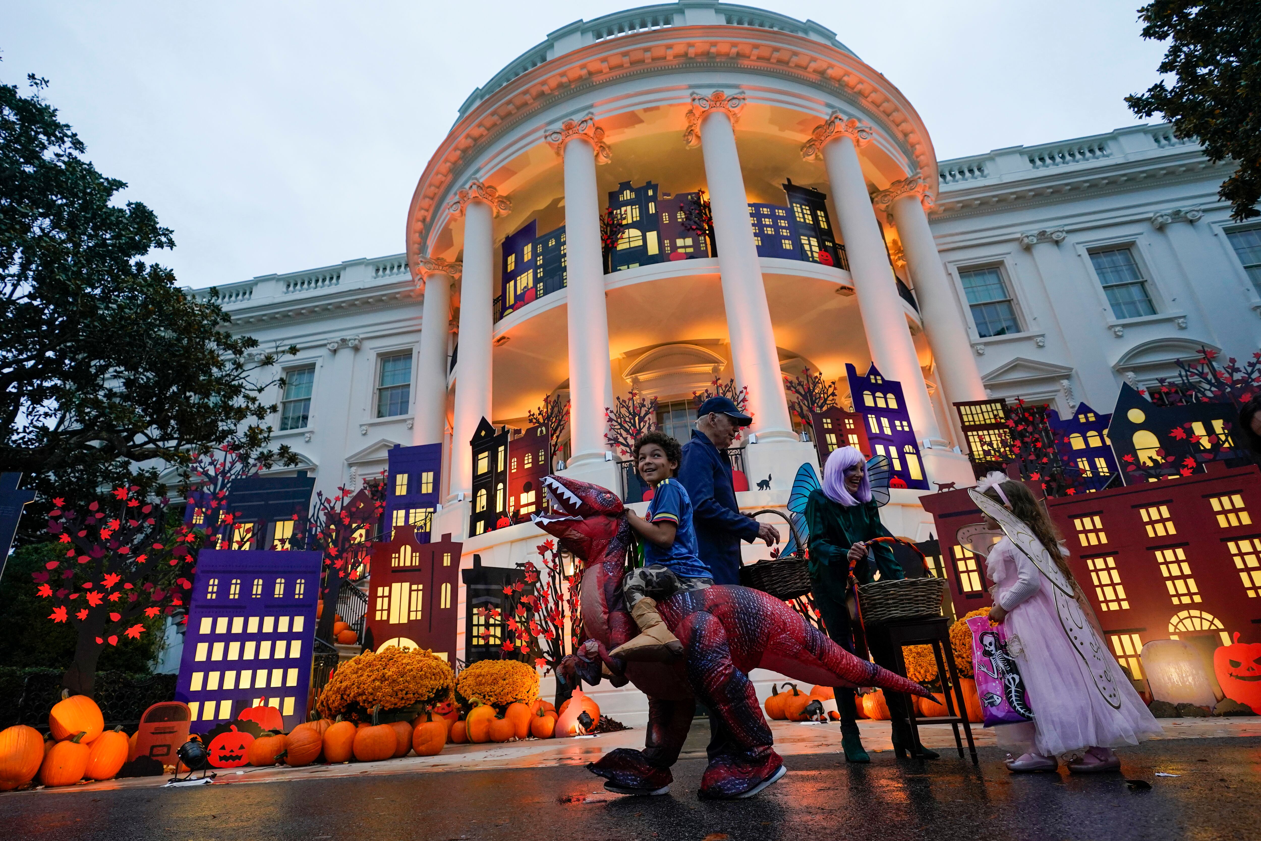 President Joe Biden and first lady Jill Biden give treats to trick-or-treaters on the South Lawn of the White House, on Halloween, Monday, Oct. 31, 2022, in Washington.