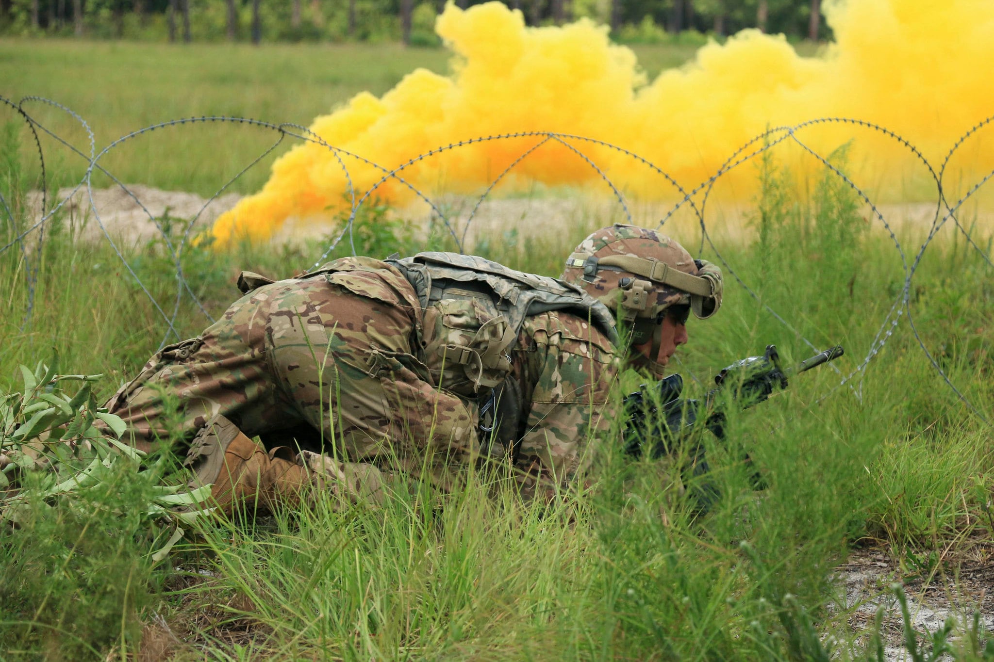 Sgt. Phillip Palmeri crawls to a breach point during a live-fire training exercise at Fort Stewart, Ga., Aug. 7, 2019.