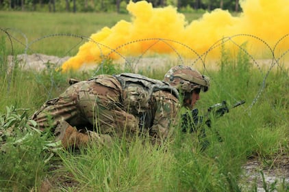 Sgt. Phillip Palmeri crawls to a breach point during a live-fire training exercise at Fort Stewart, Ga., Aug. 7, 2019.