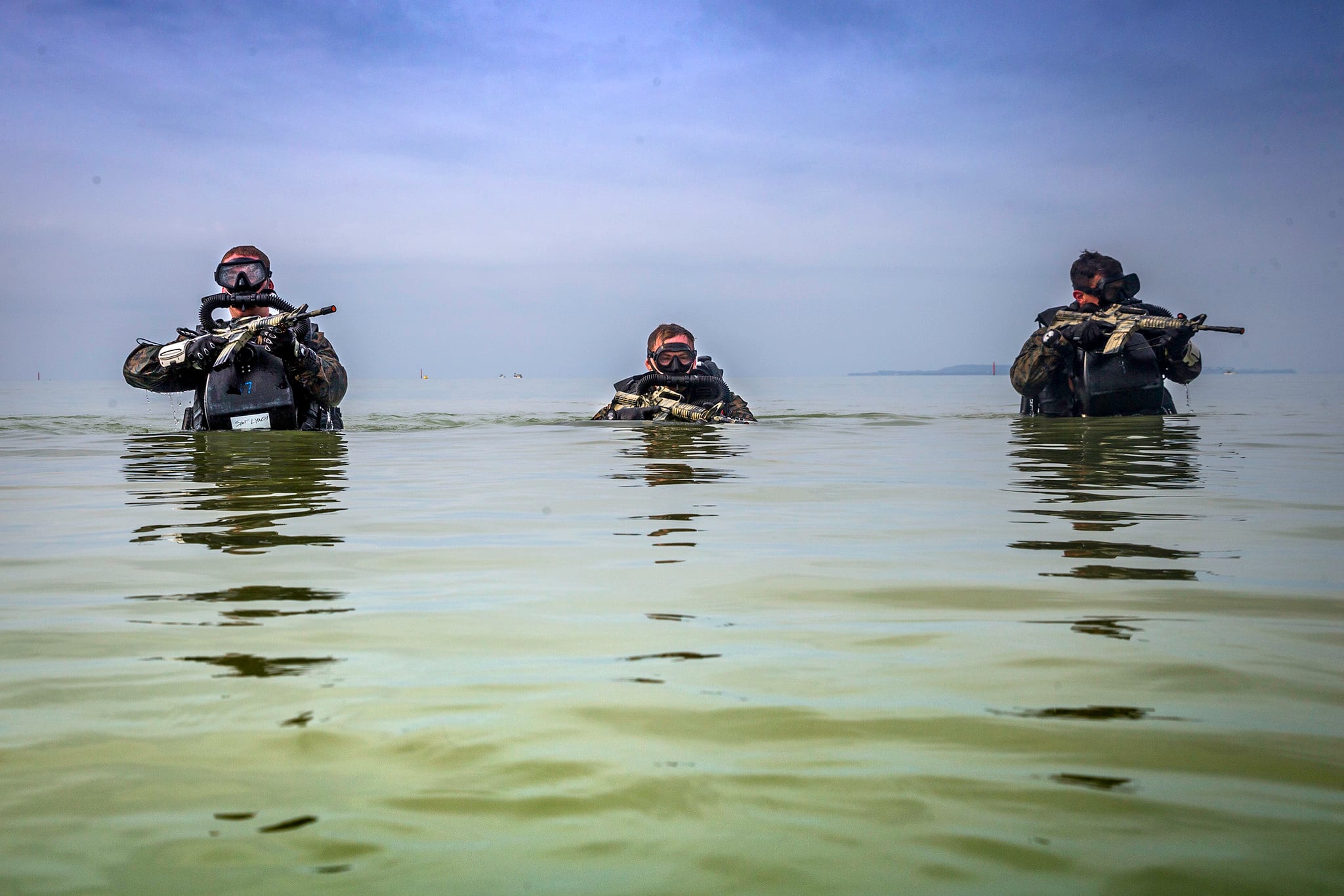 U.S. Marines patrol through water during a Marine Corps Combat Diving Supervisors Course on Camp Schwab, Okinawa, Japan, May 20, 2020.