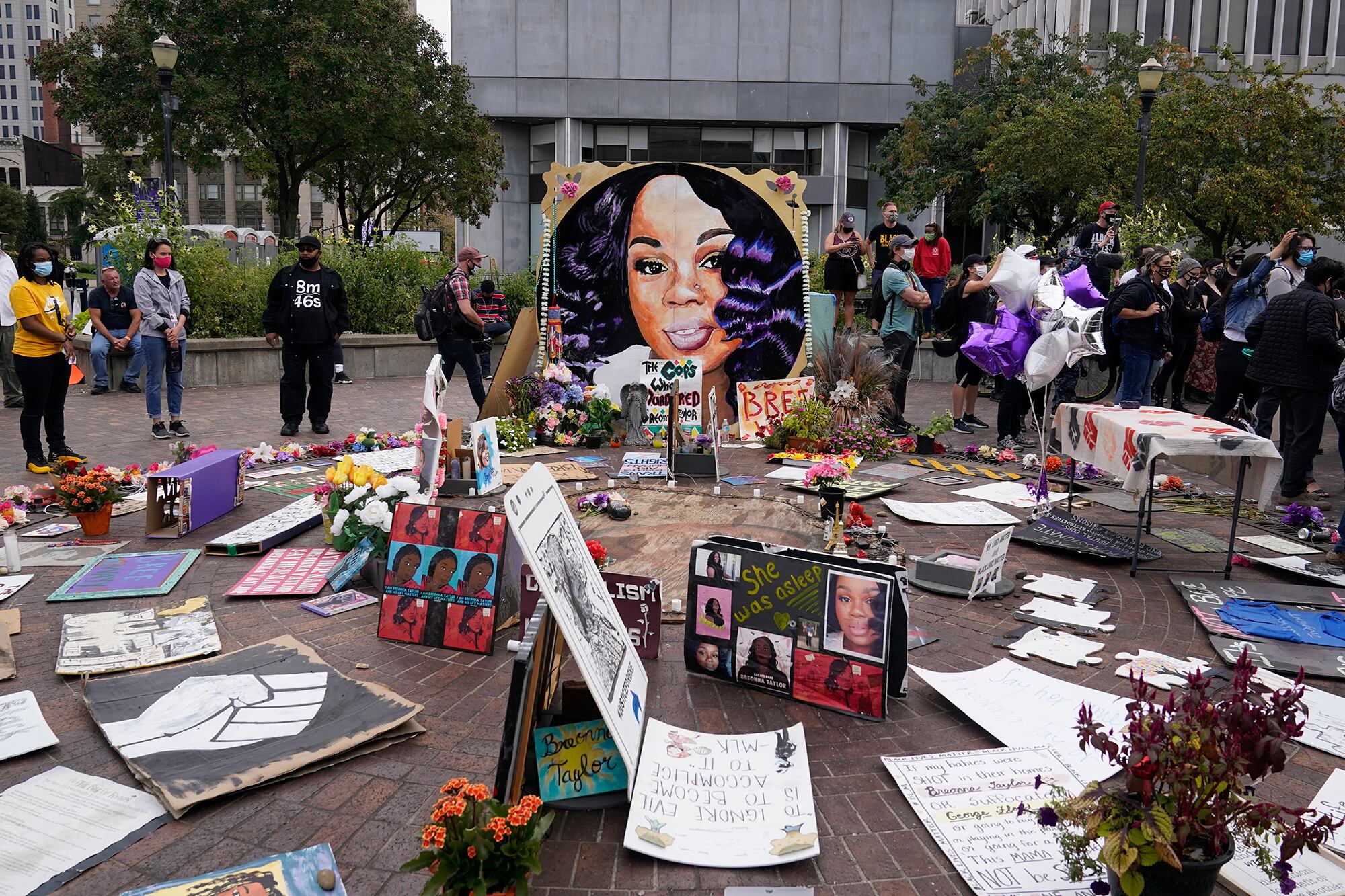 People gather in Jefferson Square awaiting word on charges against police officers, Wednesday, Sept. 23, 2020, in Louisville, Ky.