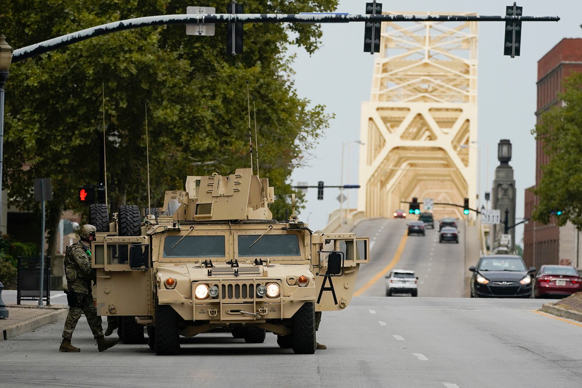 Military vehicles enter the city ahead of a 9 p.m. curfew, Wednesday, Sept. 23, 2020, in Louisville, Ky.