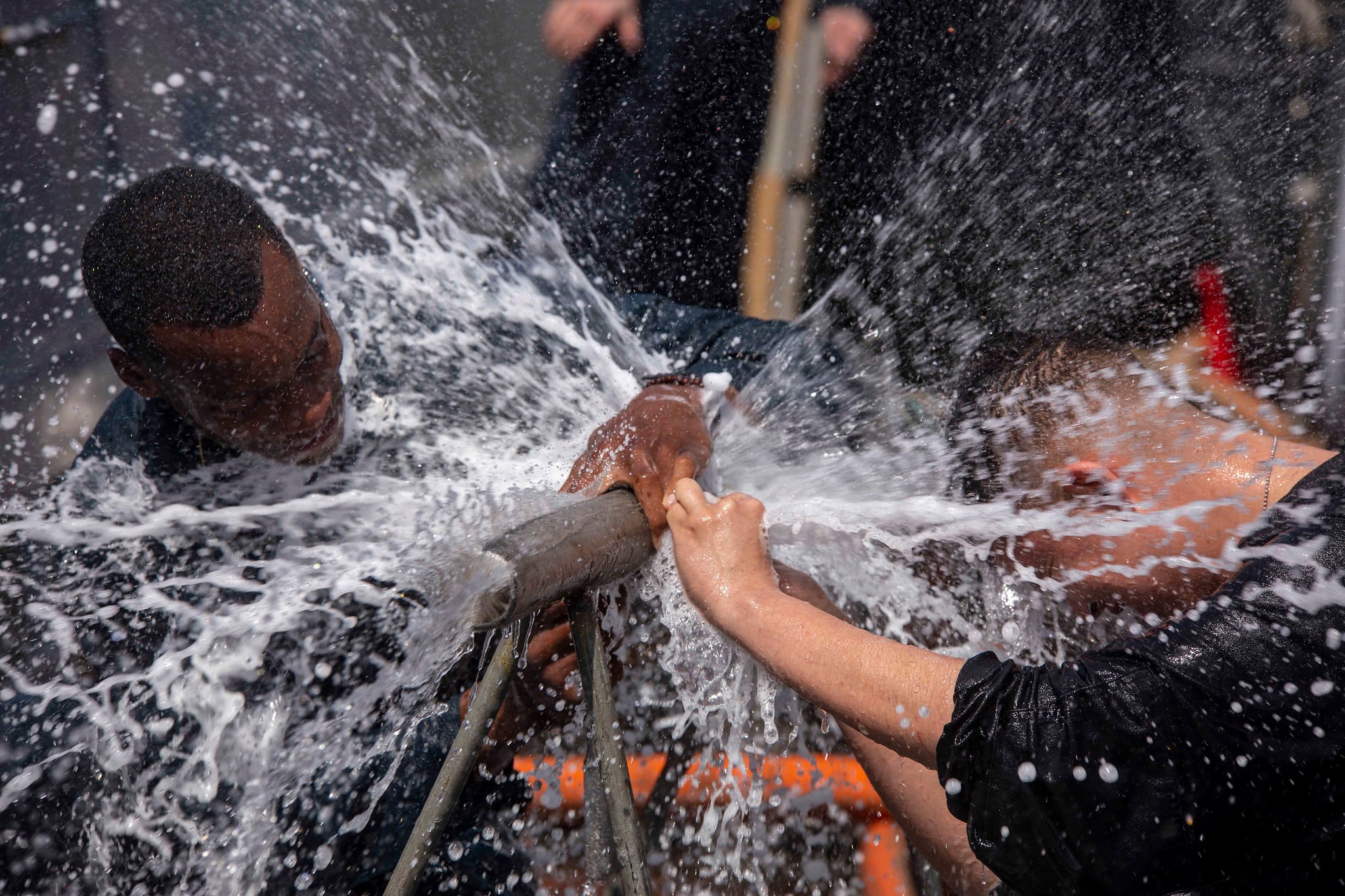 Navy sailors practice pipe patching on the fo’c’sle aboard the amphibious transport dock ship USS New York (LPD 21) during damage control training