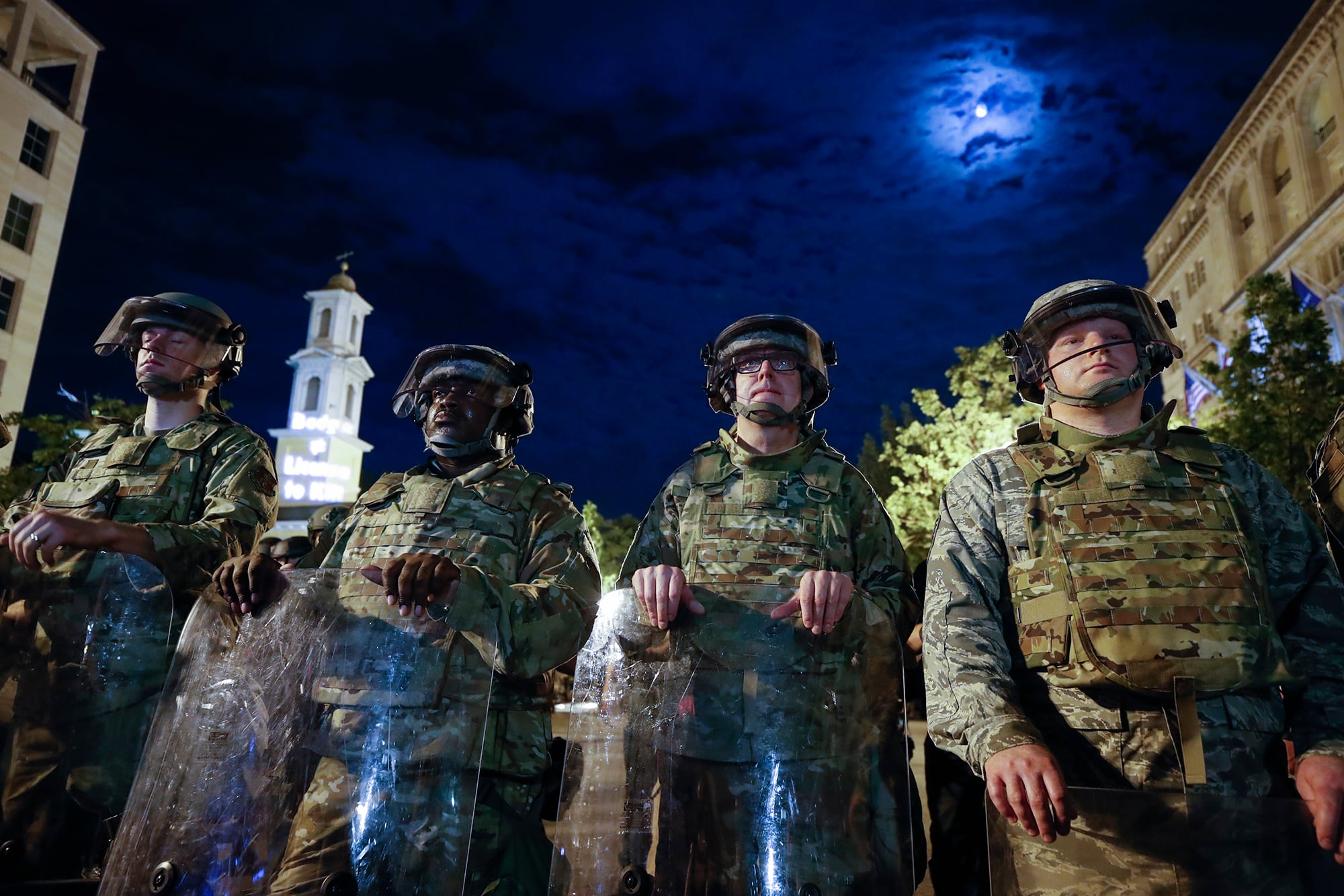 Utah National Guard soldiers stand on a police line as demonstrators gather to protest the death of George Floyd, Thursday, June 4, 2020, near the White House in Washington.