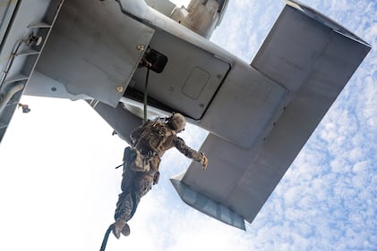 Marines fast rope out of an MV-22B Osprey aboard amphibious assault ship USS America (LHA 6) on Aug. 23, 2020, in the Philippine Sea.