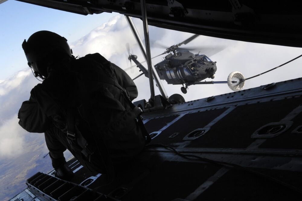 Staff Sgt. Jeremy Mayo, a 9th Special Operations Squadron loadmaster aboard a C-130P, looks for signs of difficulty during an aerial refueling mission over Fort Campbell, Kentucky, Dec. 2, 2008. (Senior Airman Julianne Showalter/Air Force)