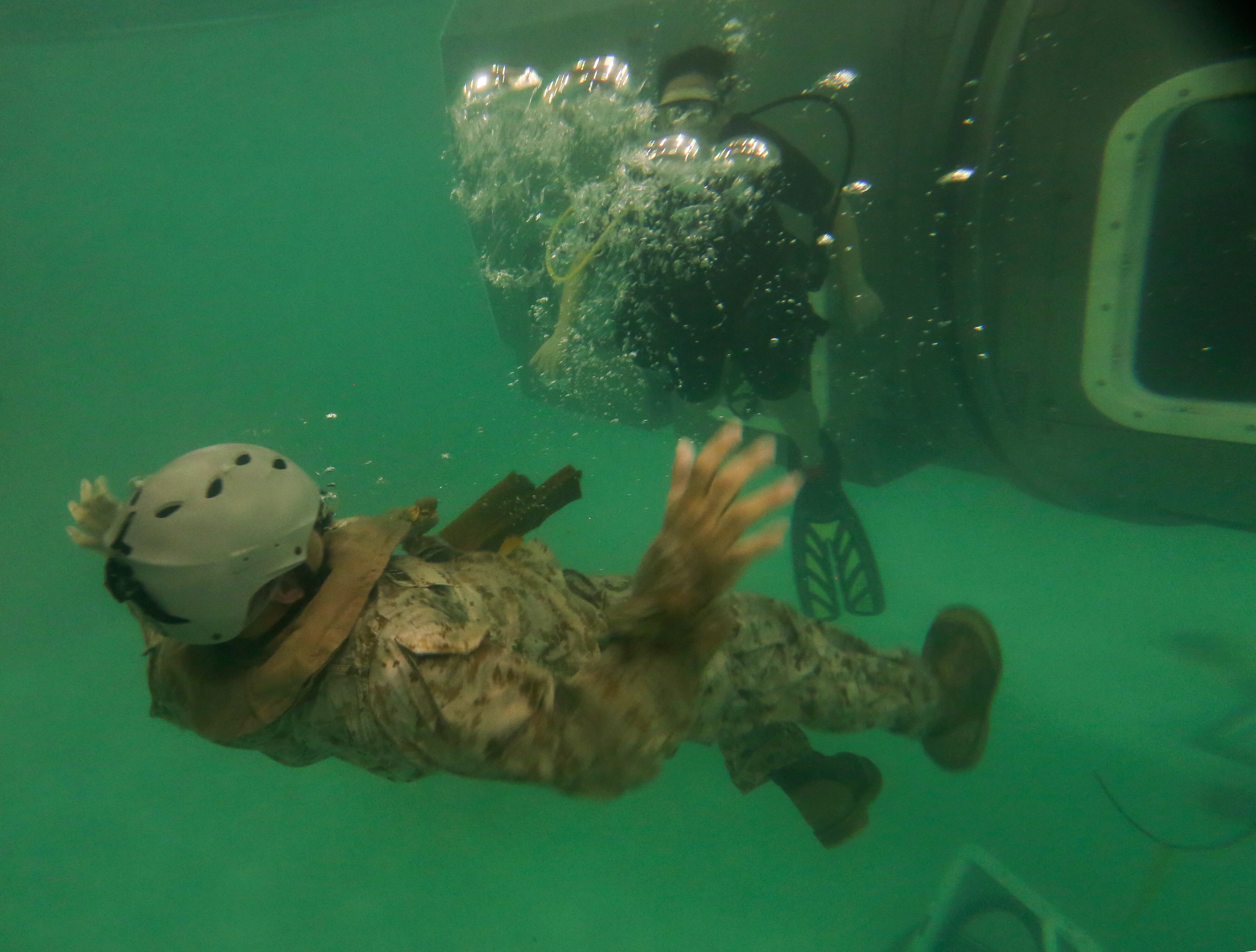 A Marine with the 26th Marine Expeditionary Unit conducts evacuation procedures out of a Modular Amphibious Egress Trainer during underwater egress training at the water survival training center aboard Marine Corps Base Camp Lejeune, N.C., March 24, 2015.